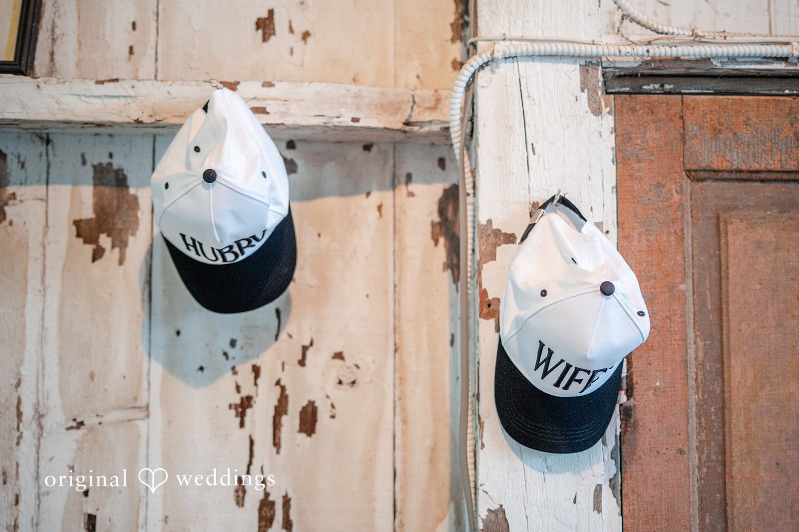 Rustic hats hanging on a barn wall