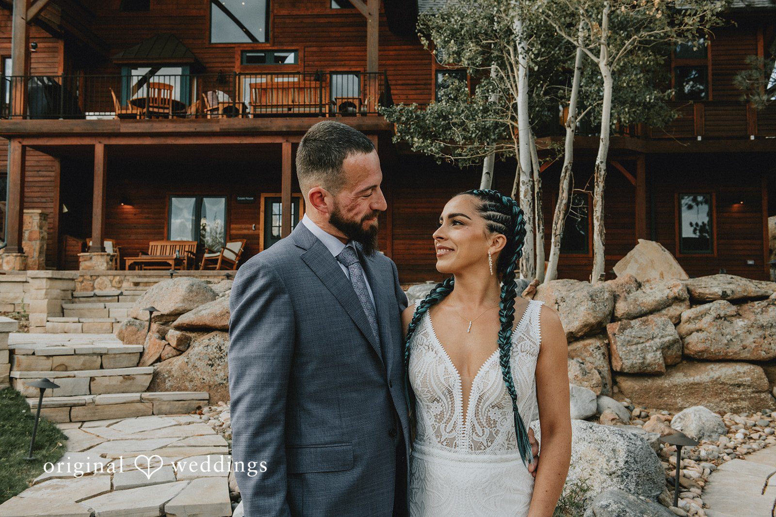 Johana + Arthur Johana and Arthur posing in front of the mountain lodge, captured by Denver wedding photographers from Original Weddings at Aspen Falls