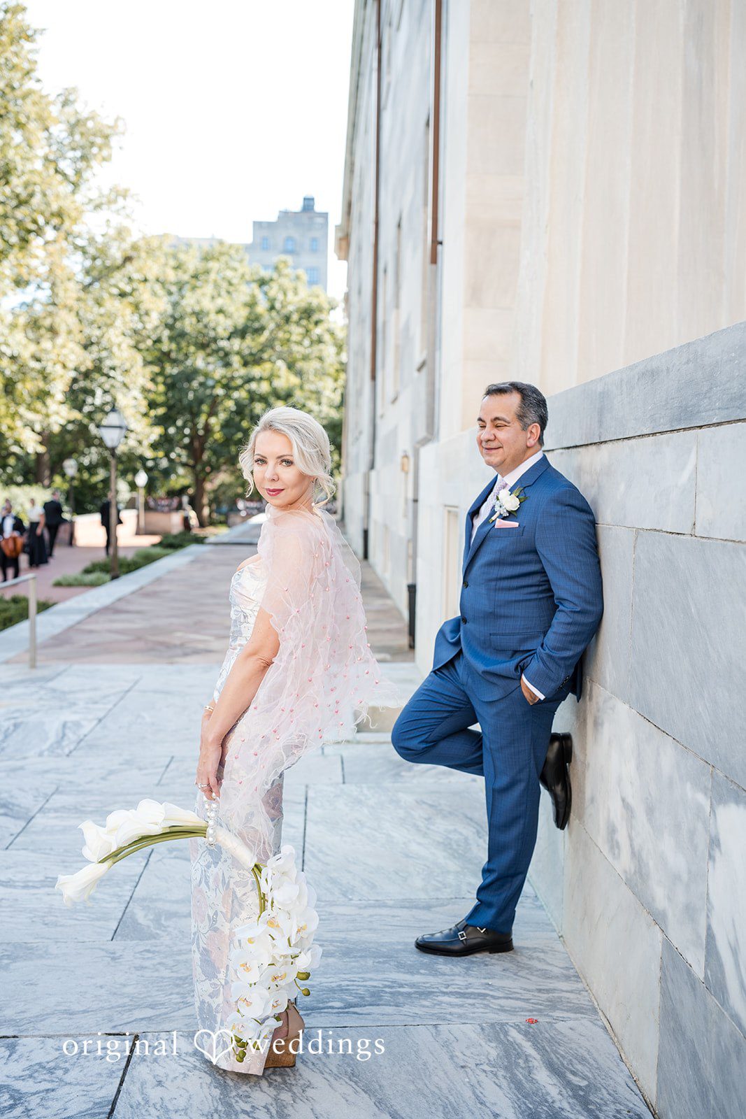 Alexandra + John Groom leaning on a column with the bride nearby at Barclay Prime