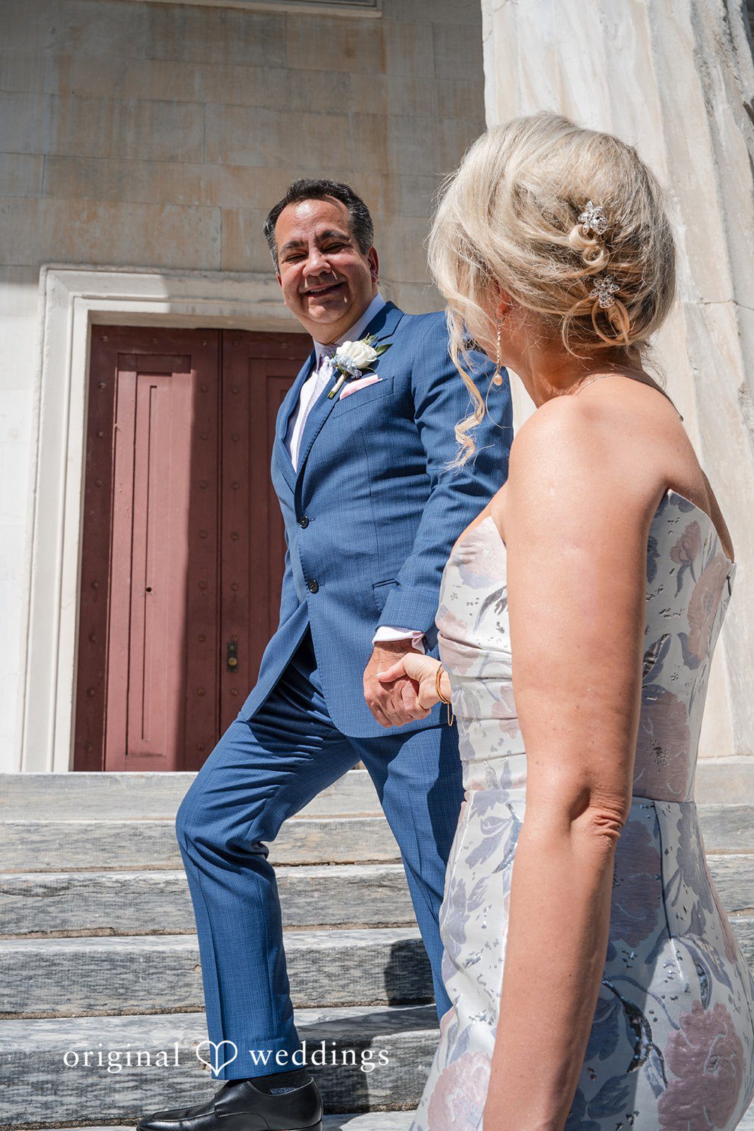 Alexandra + John Groom laughing by a red door