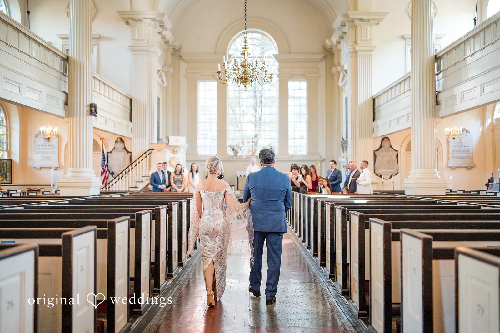 Alexandra + John Bride and groom walking down the church aisle