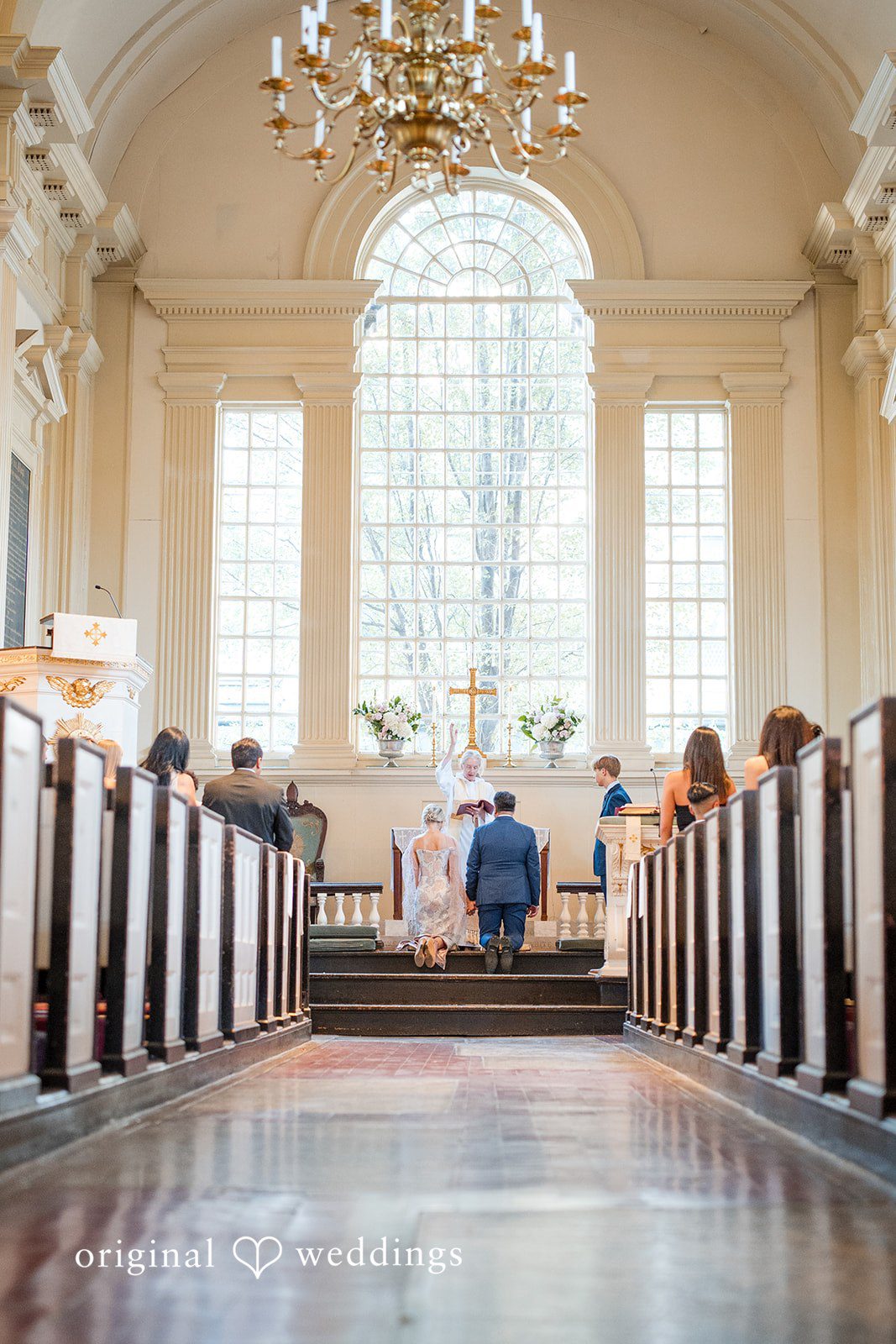 Alexandra + John Historic church interior with a chandelier at Barclay Prime