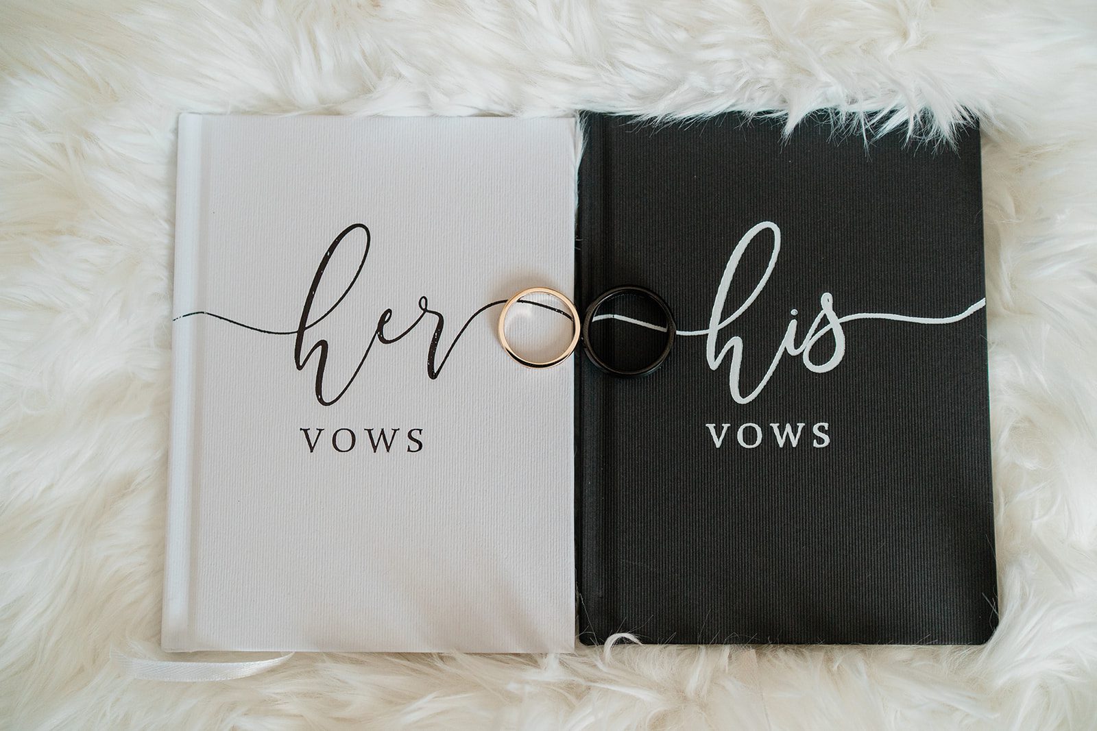 Her and his vow books on a fur blanket