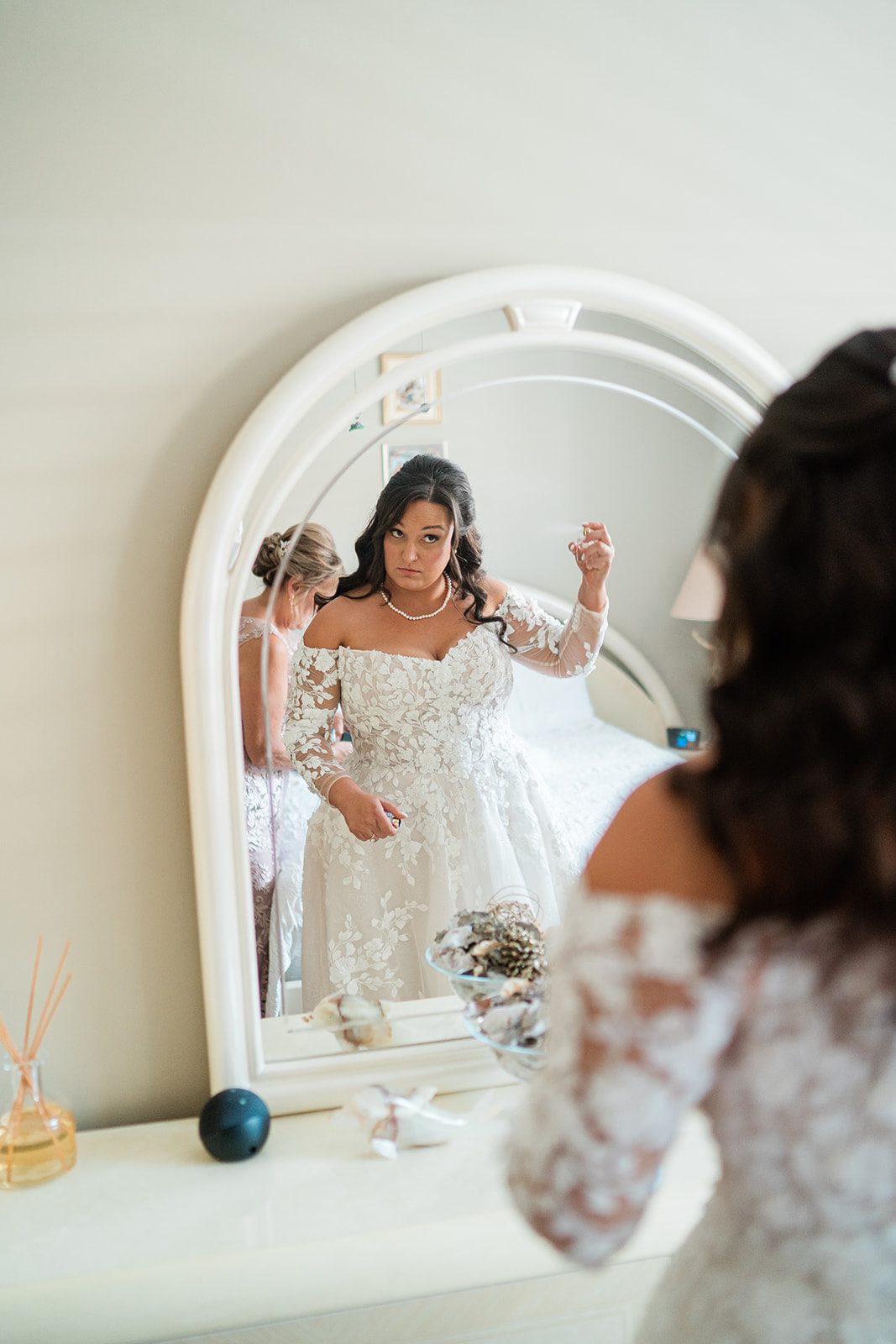 Bride getting ready in front of the mirror