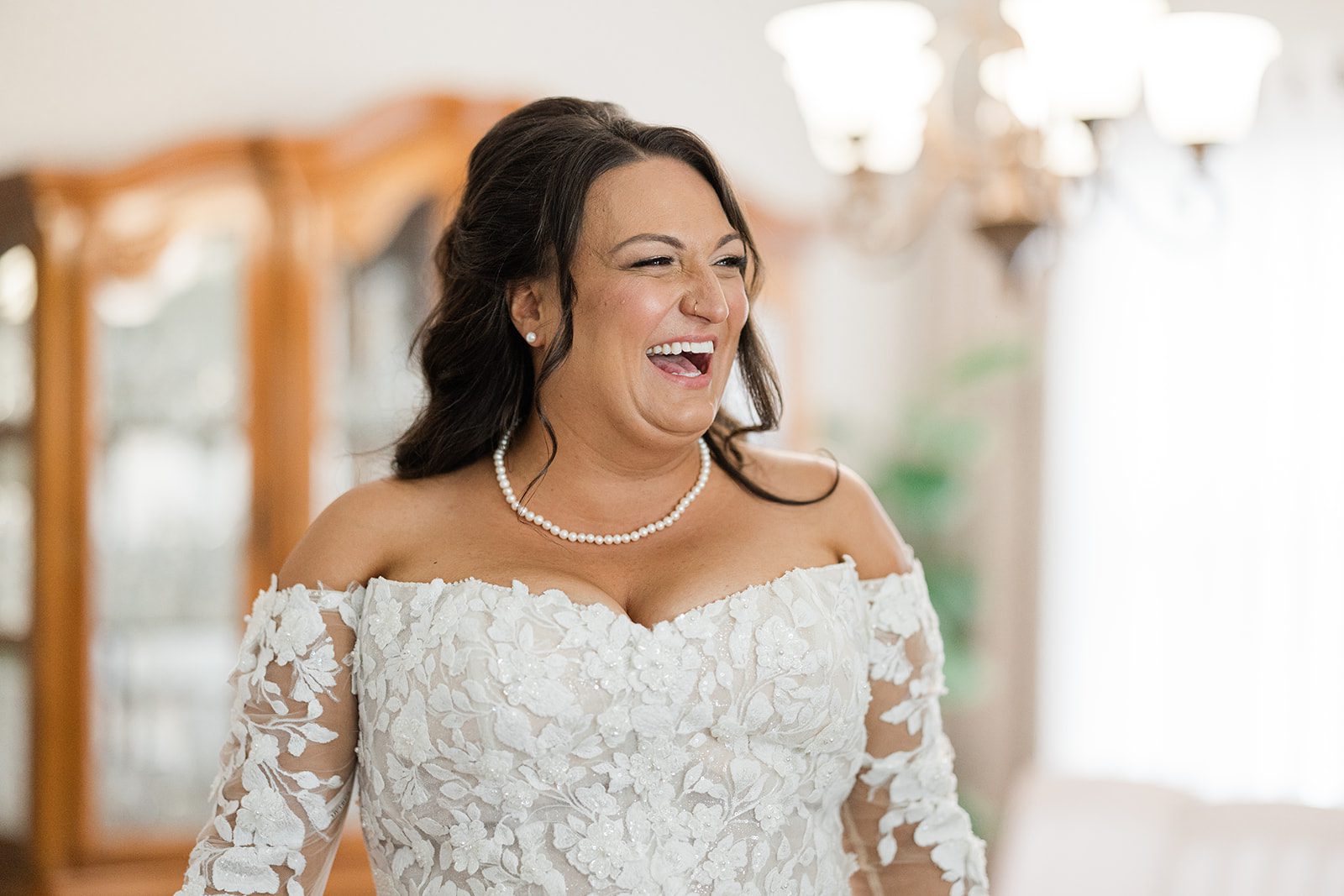 Bride smiling in her lace wedding gown
