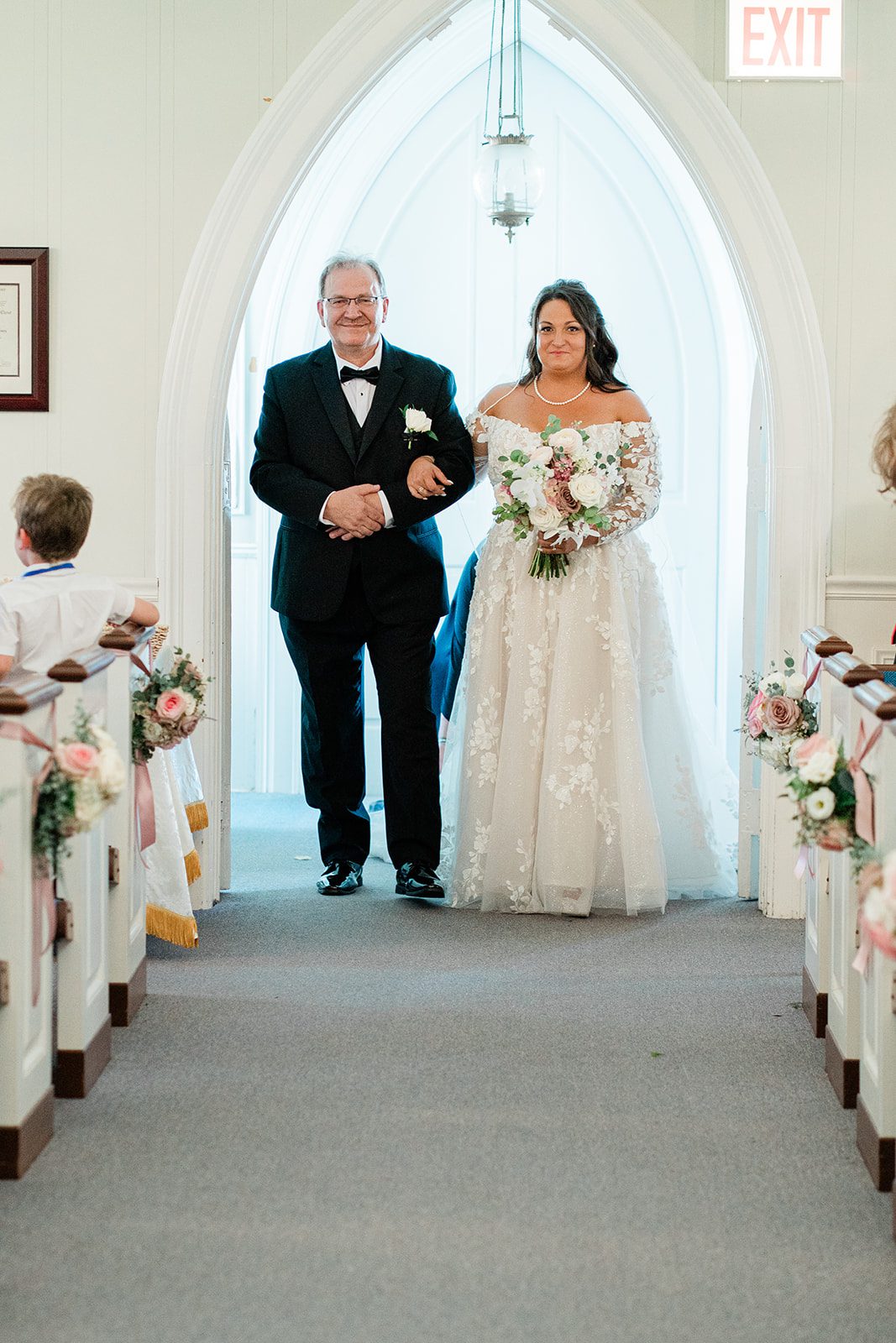 Bride walking down the church aisle with her father