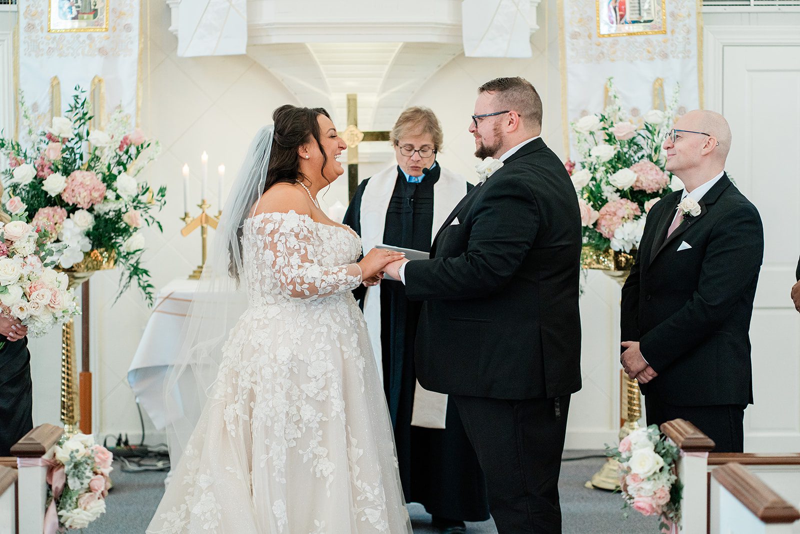 Couple holding hands at the altar