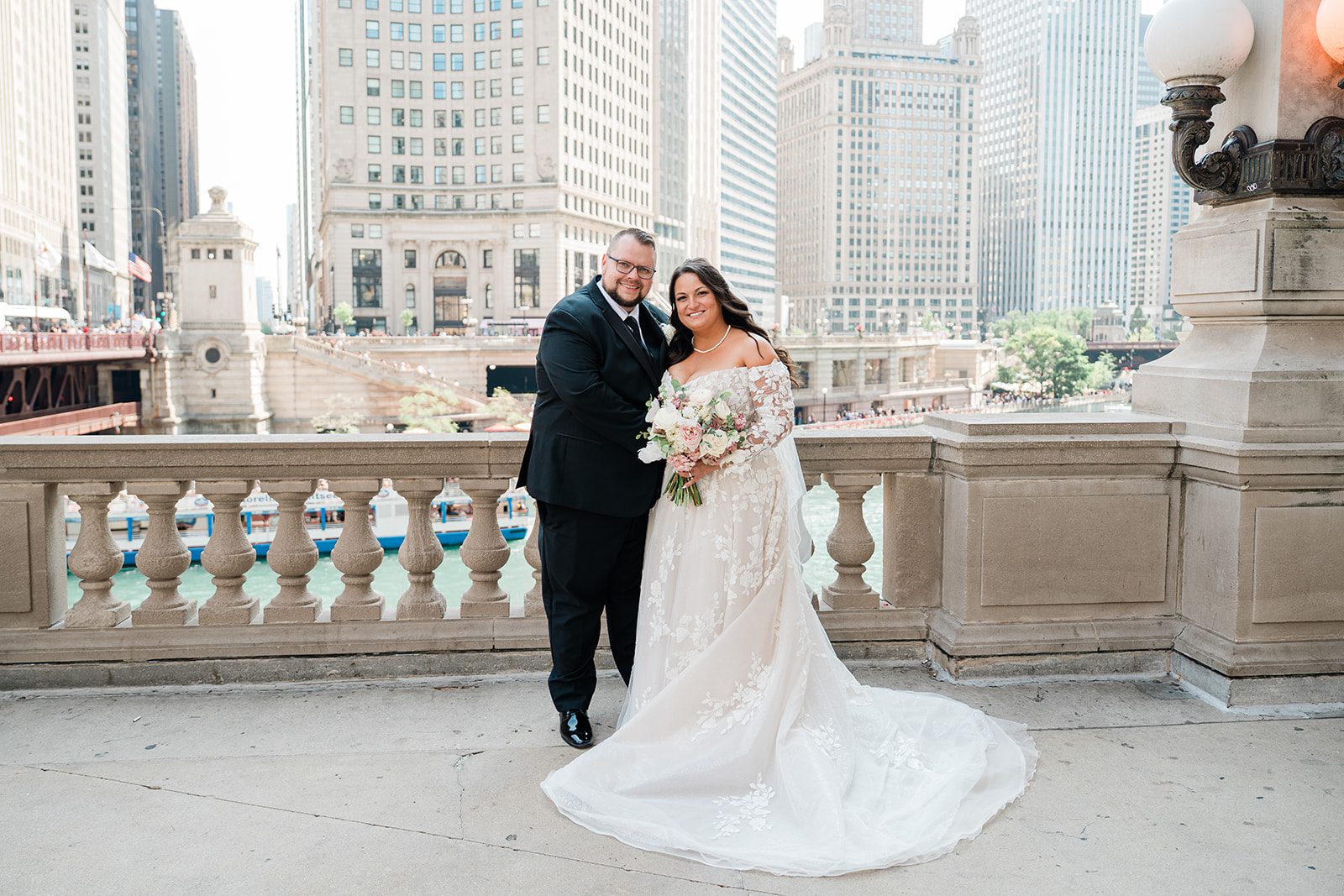 Couple posing by the stone railing downtown