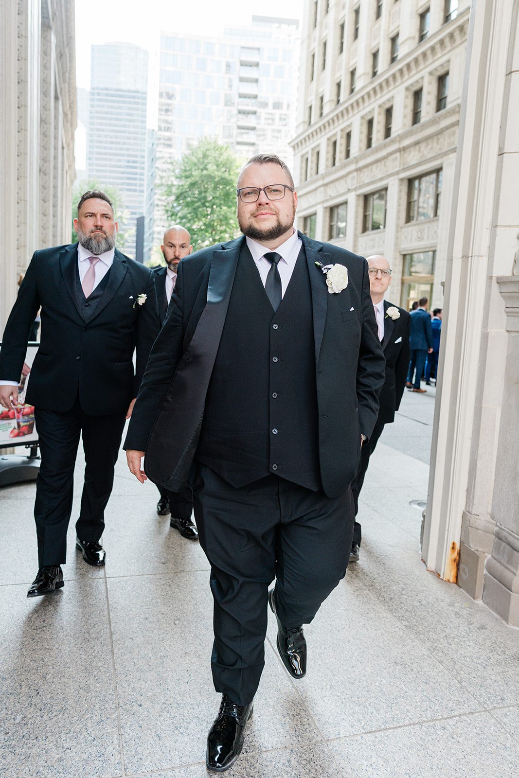Groom walking along the riverwalk