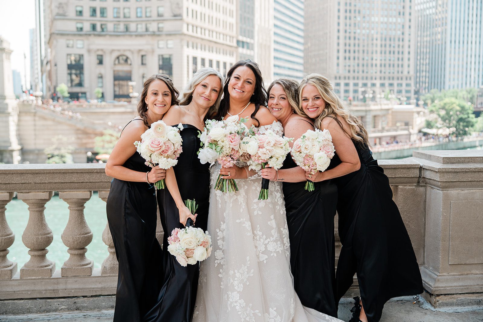 Bride with her bridesmaids in black dresses