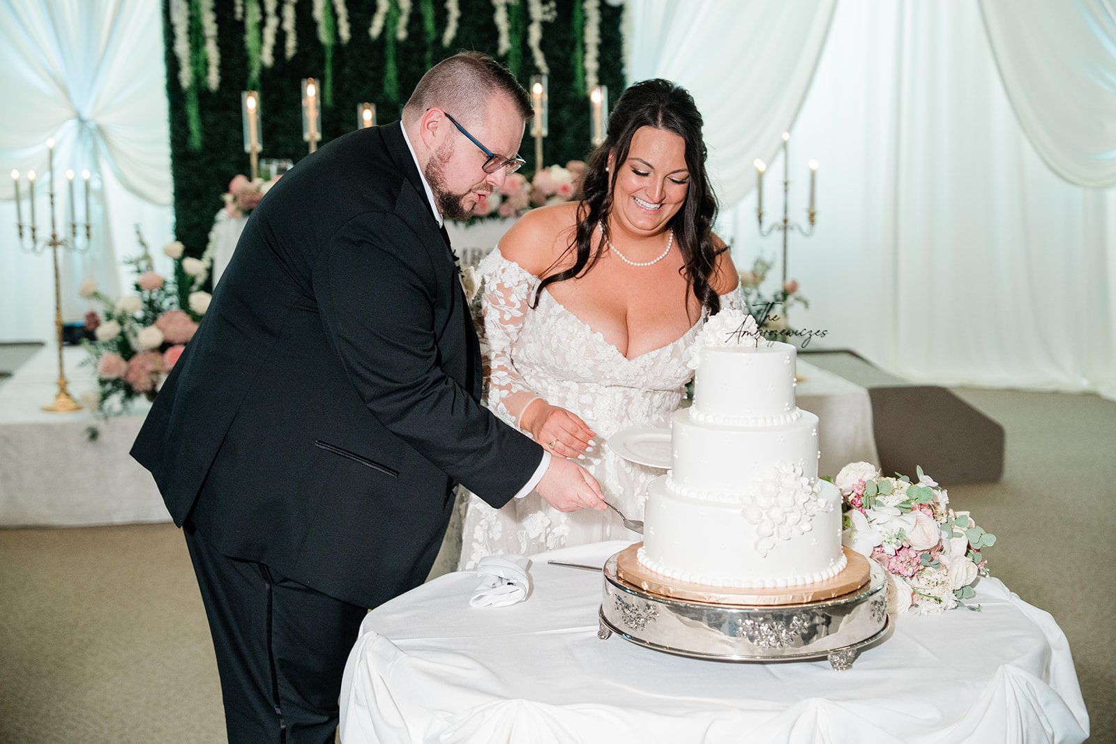 Couple cutting their wedding cake at Belvedere & Co. Events