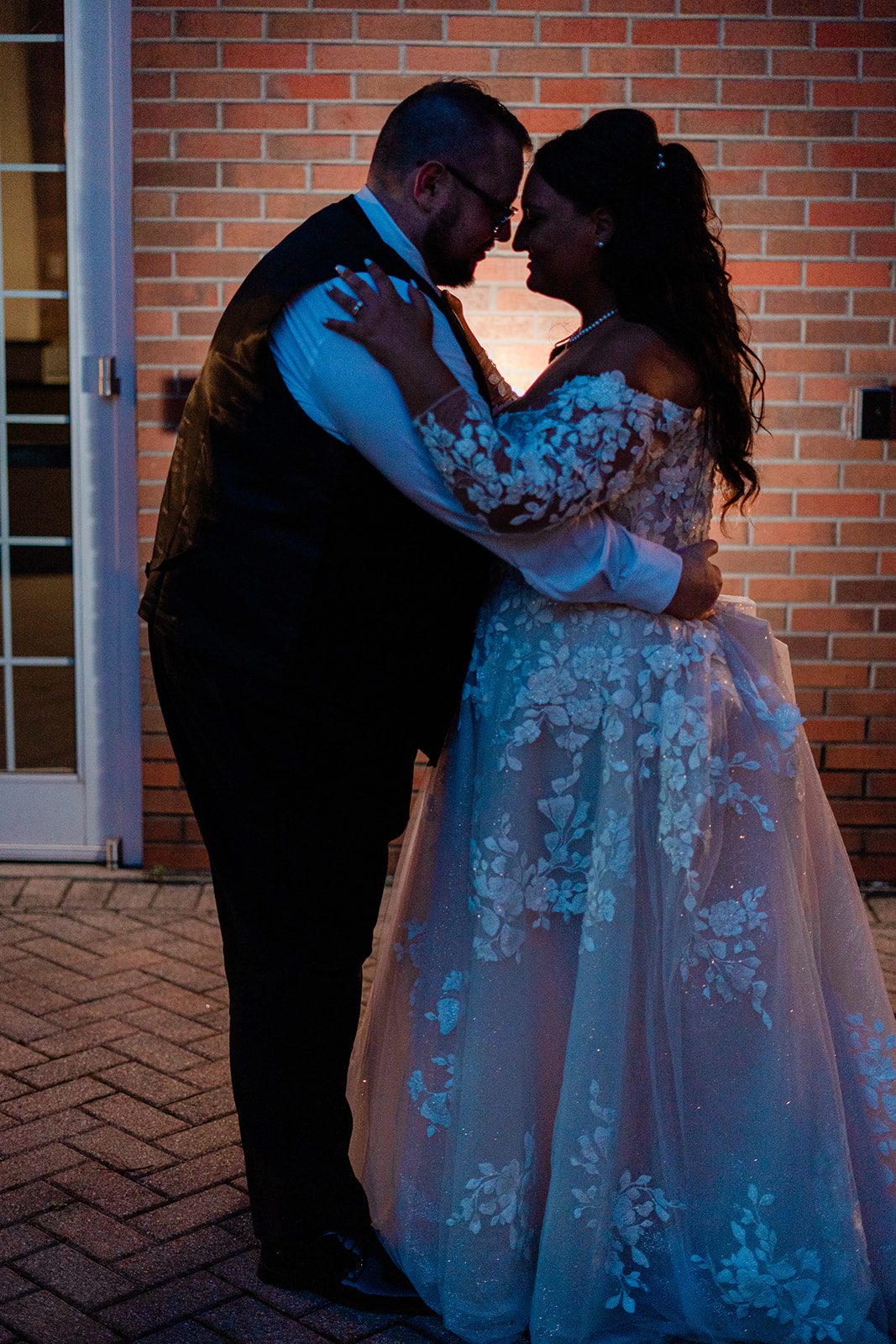 Couple dancing under colorful lights
