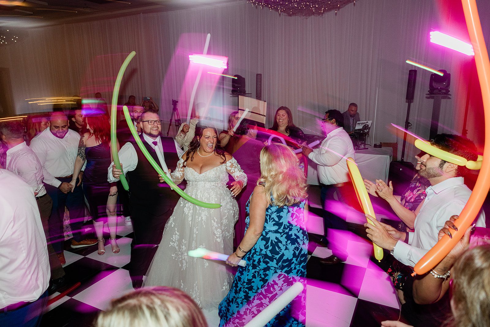 Guests dancing with glow sticks at Belvedere & Co. Events