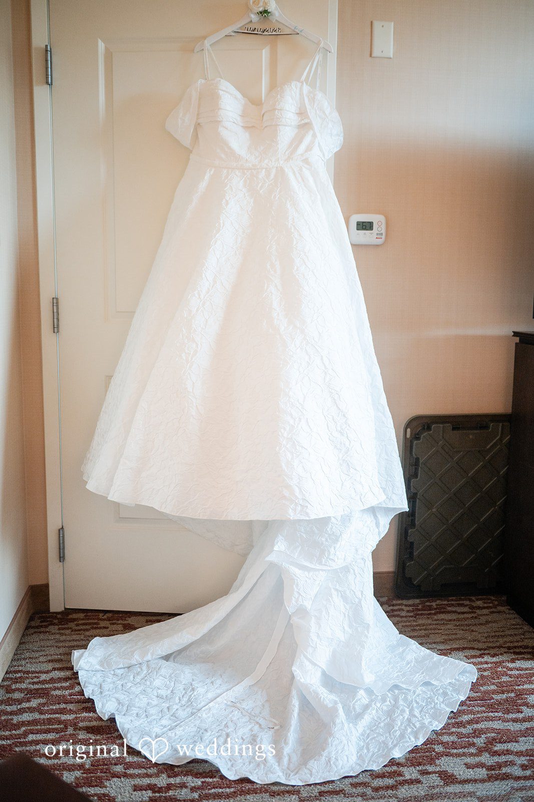Erika's wedding dress hanging before the ceremony