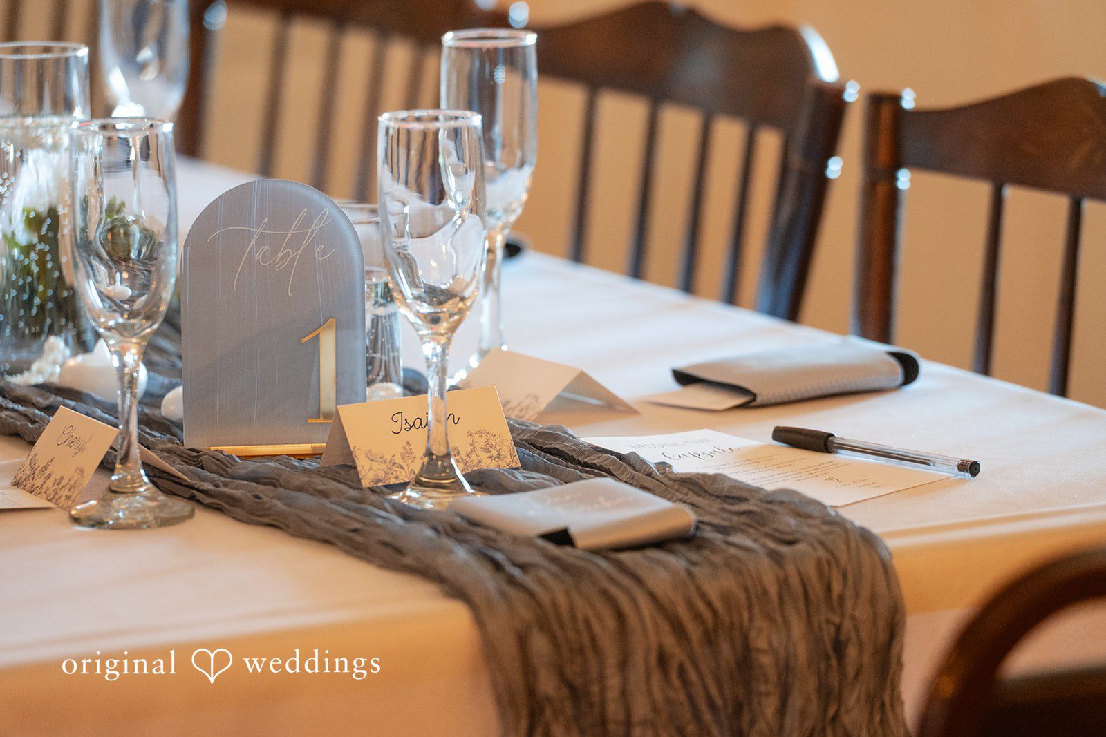 Table setting with a burlap runner and glassware