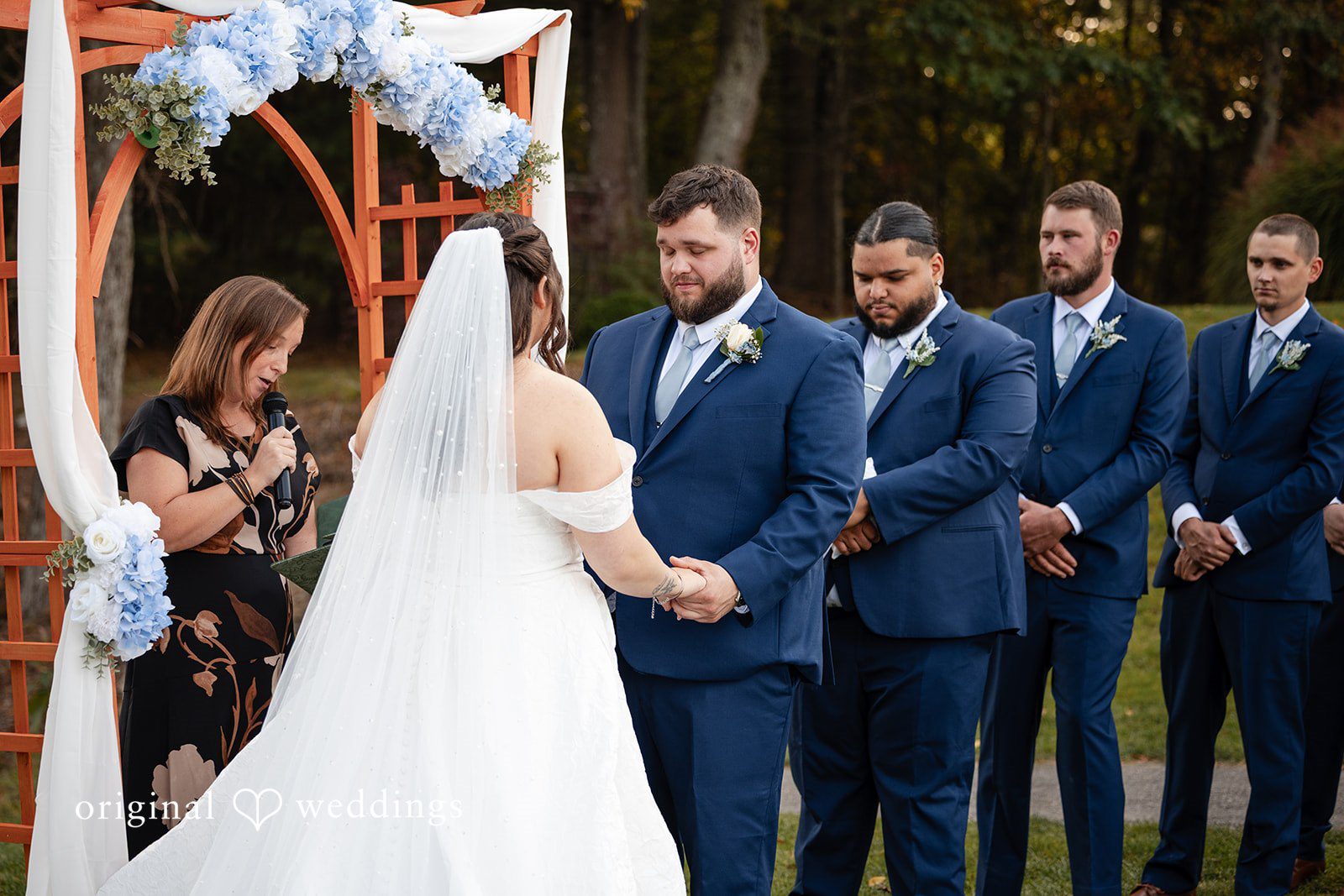Bride with the groomsmen in navy suits
