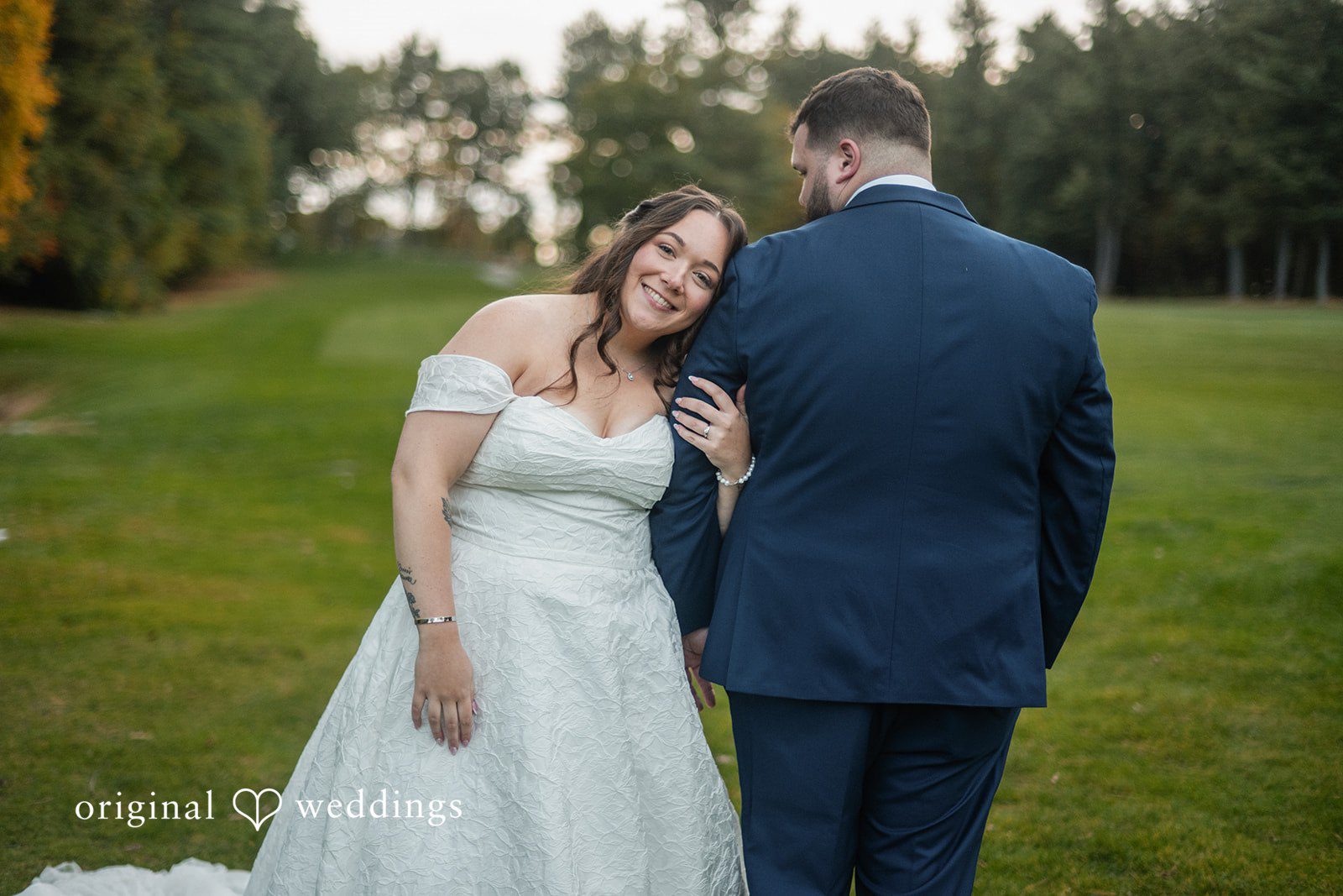 Erika and Daniel laughing together on the lawn at Berlin Country Club