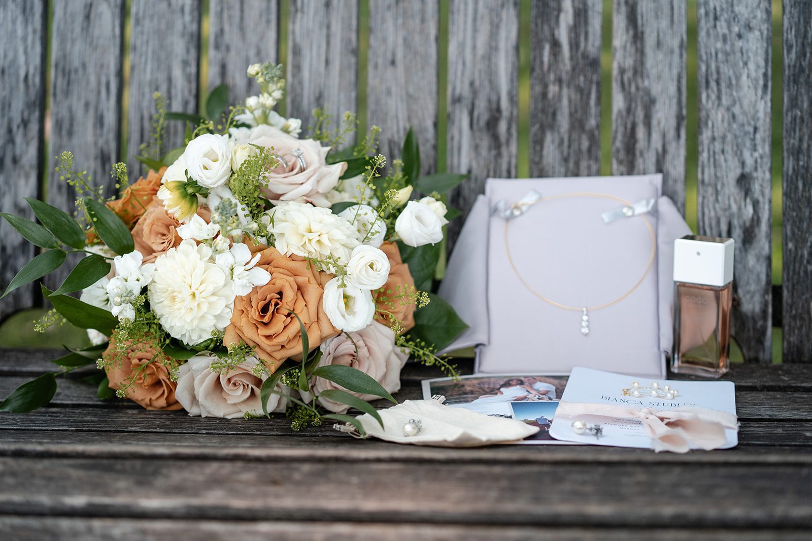 bishops-bay-country-club-timeless-madison-bianca-colin-p004-01 Bridal bouquet and wedding details on a wooden table