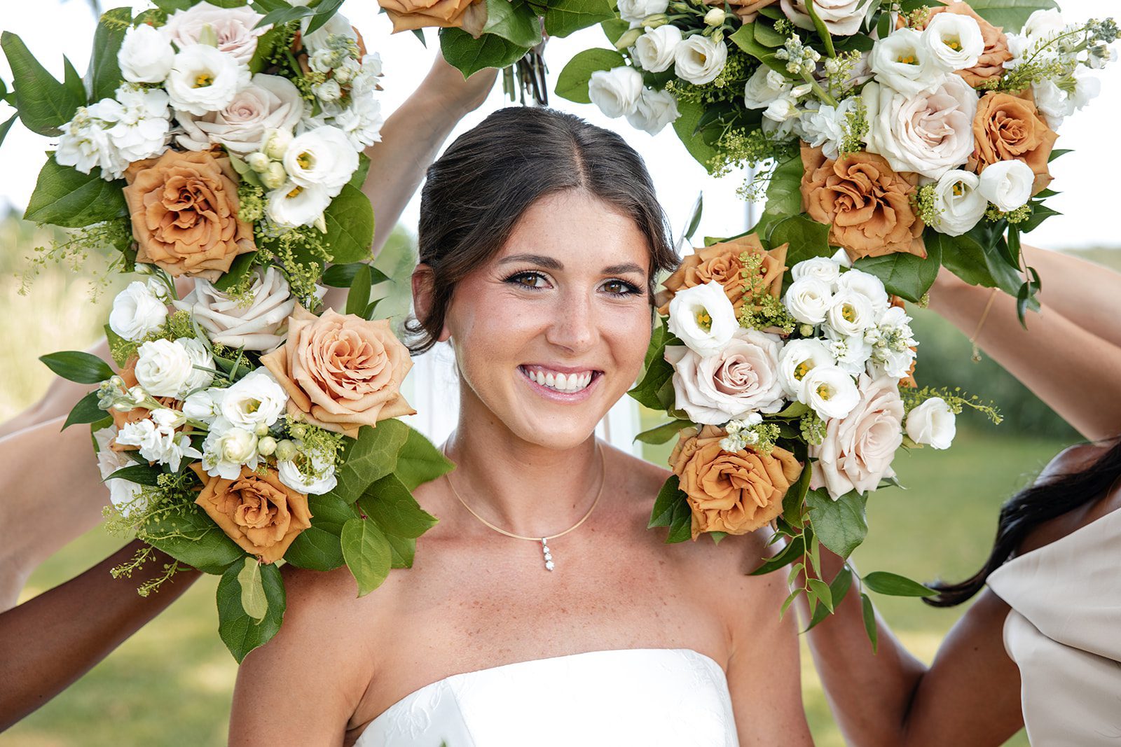 bishops-bay-country-club-timeless-madison-bianca-colin-p010-01 Bride framed by bouquets from her bridesmaids