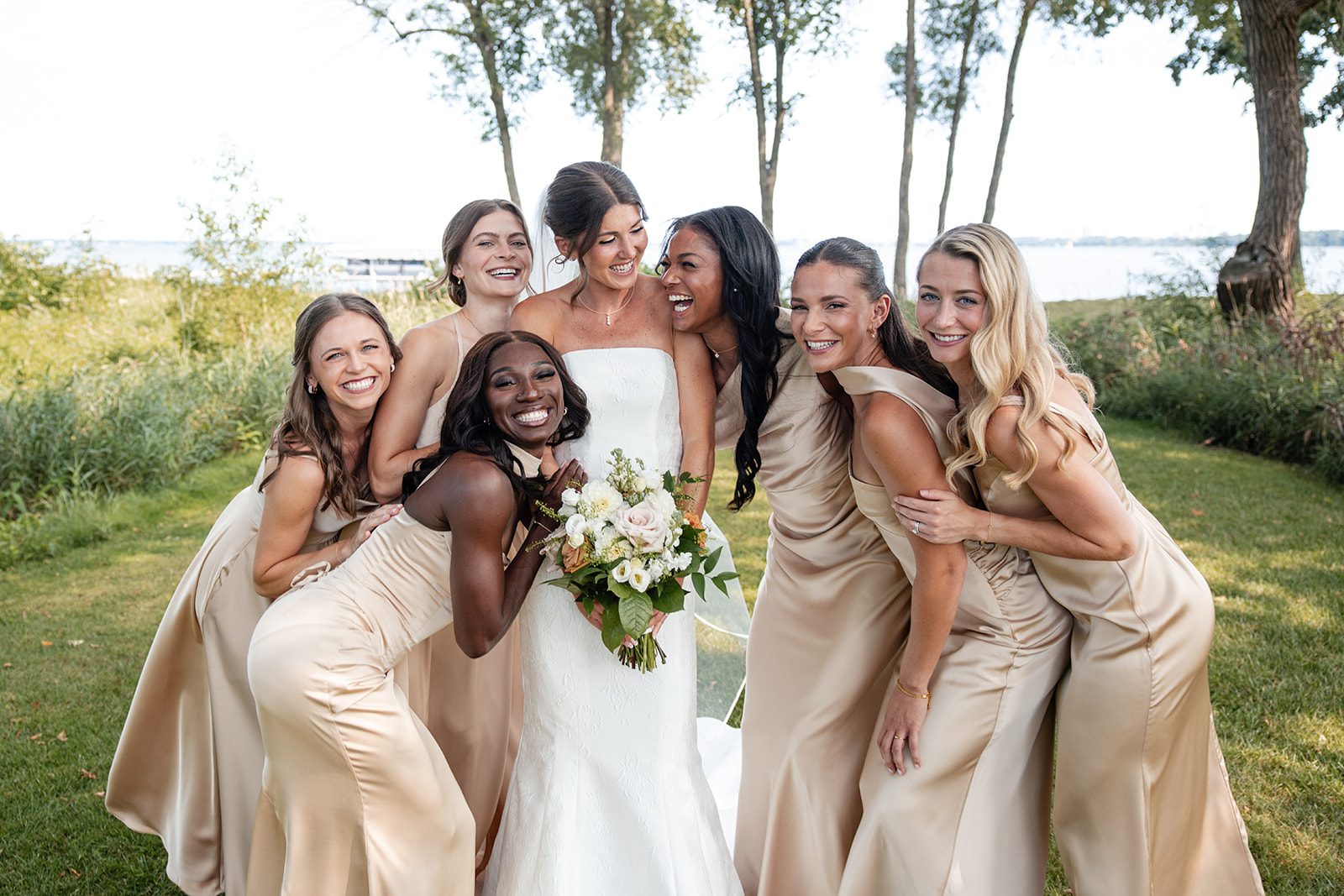 bishops-bay-country-club-timeless-madison-bianca-colin-p011-01 Bride laughing with her bridesmaids at Bishops Bay Country Club