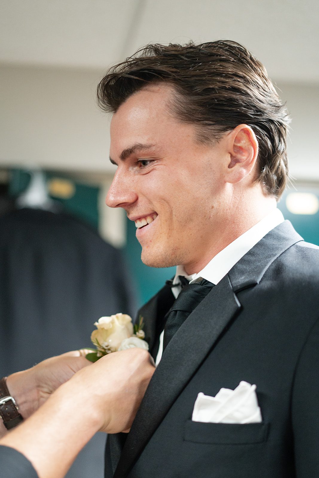 bishops-bay-country-club-timeless-madison-bianca-colin-p014-06 Groom having his boutonniere pinned
