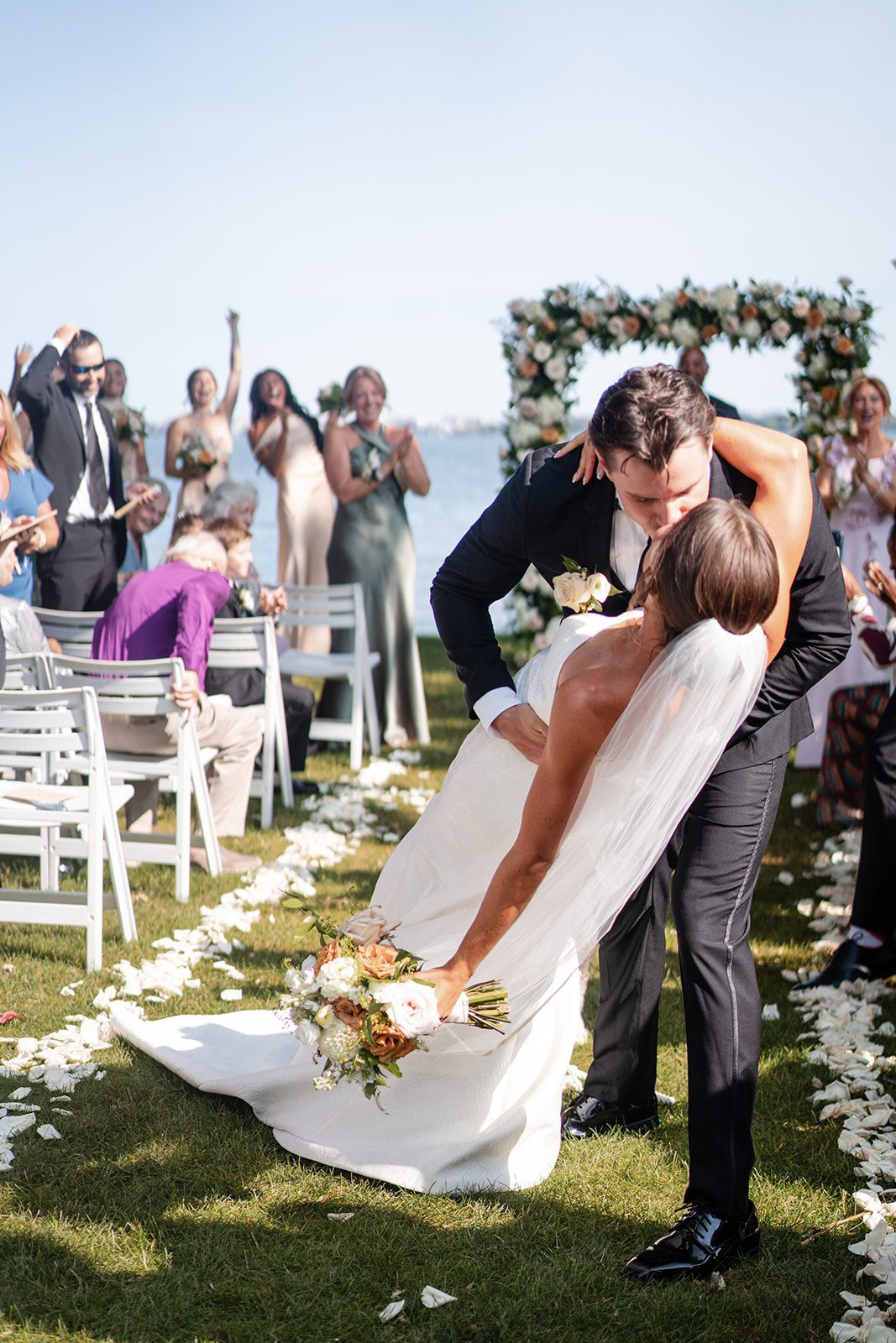 bishops-bay-country-club-timeless-madison-bianca-colin-p023-01 Groom dipping the bride for a kiss at the end of the aisle