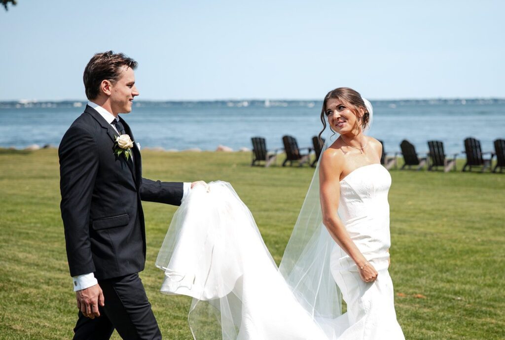 Bride and groom meeting on the lakeside lawn, captured by Madison wedding photographers from Original Weddings at Bishops Bay Country Club