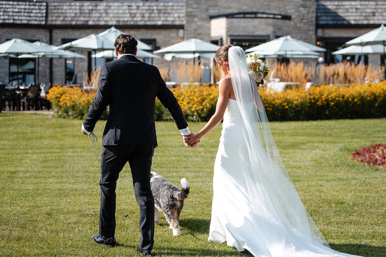 bishops-bay-country-club-timeless-madison-bianca-colin-p034-01 Bride and groom walking across the lawn