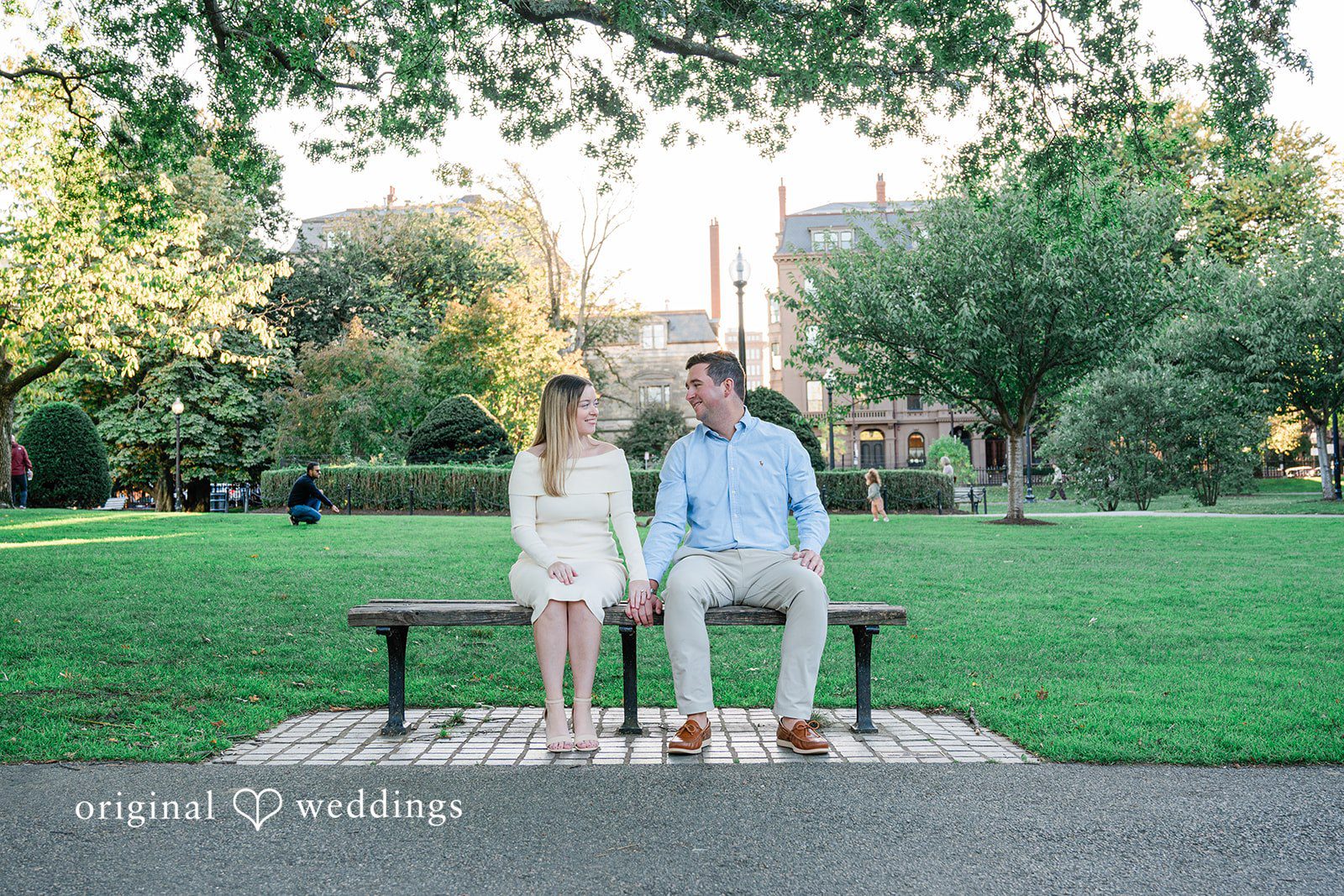 October 06, 2026 – Alice & Austin – (ID-6084) Couple sitting on a bench across the lawn at Boston Public Garden