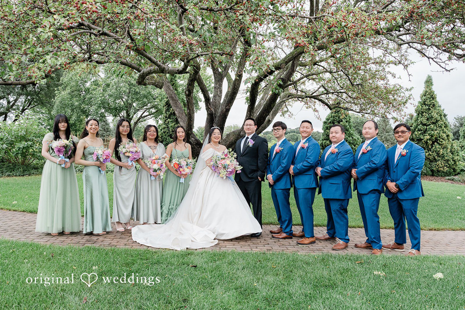Josouaedh + Naochue Our Minneapolis wedding photographers captured a beautiful portrait of the couple and their bridal party at Brackett's Crossing Country Club