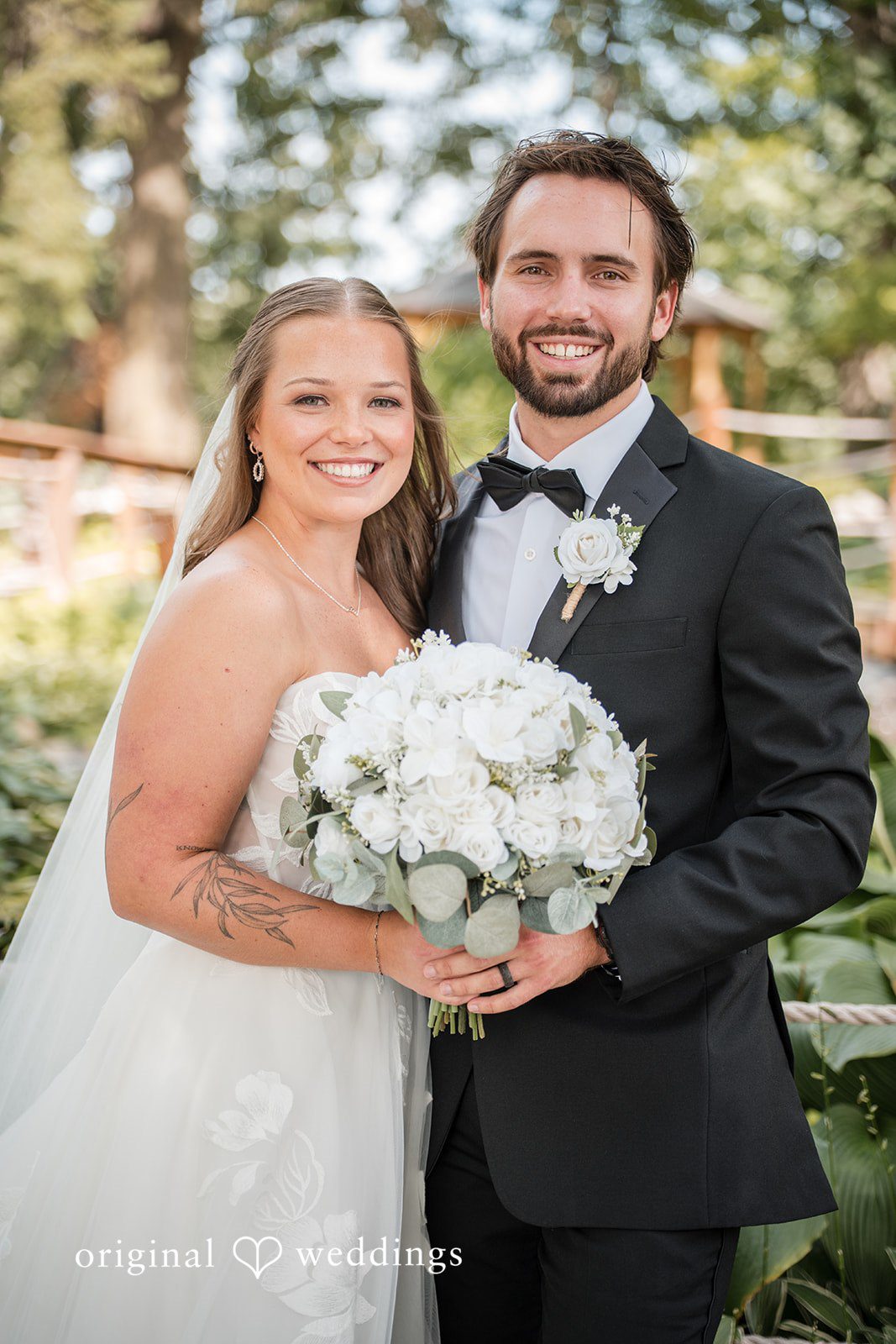 Couple smiling with the bouquet at Brianos Charthouse Lakeville