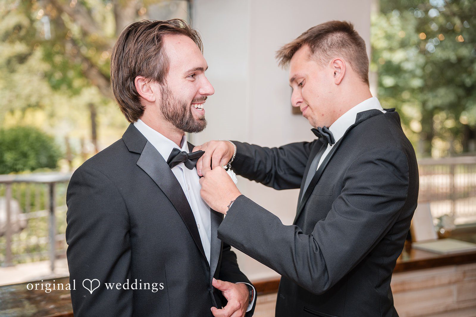 Groomsman helping the groom get ready