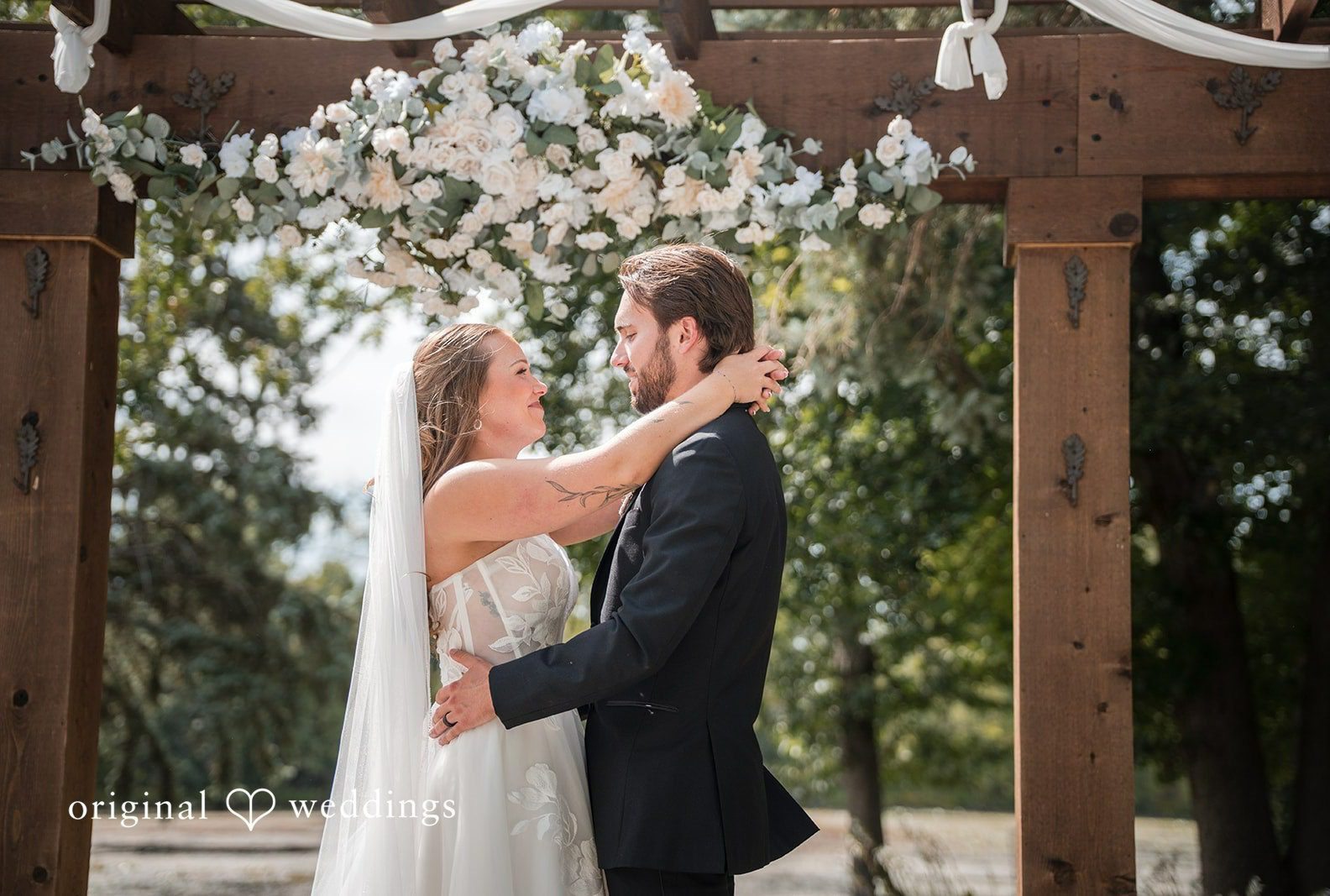 Couple under the pergola, captured by Minneapolis wedding photographers from Original Weddings at Brianos Charthouse Lakeville