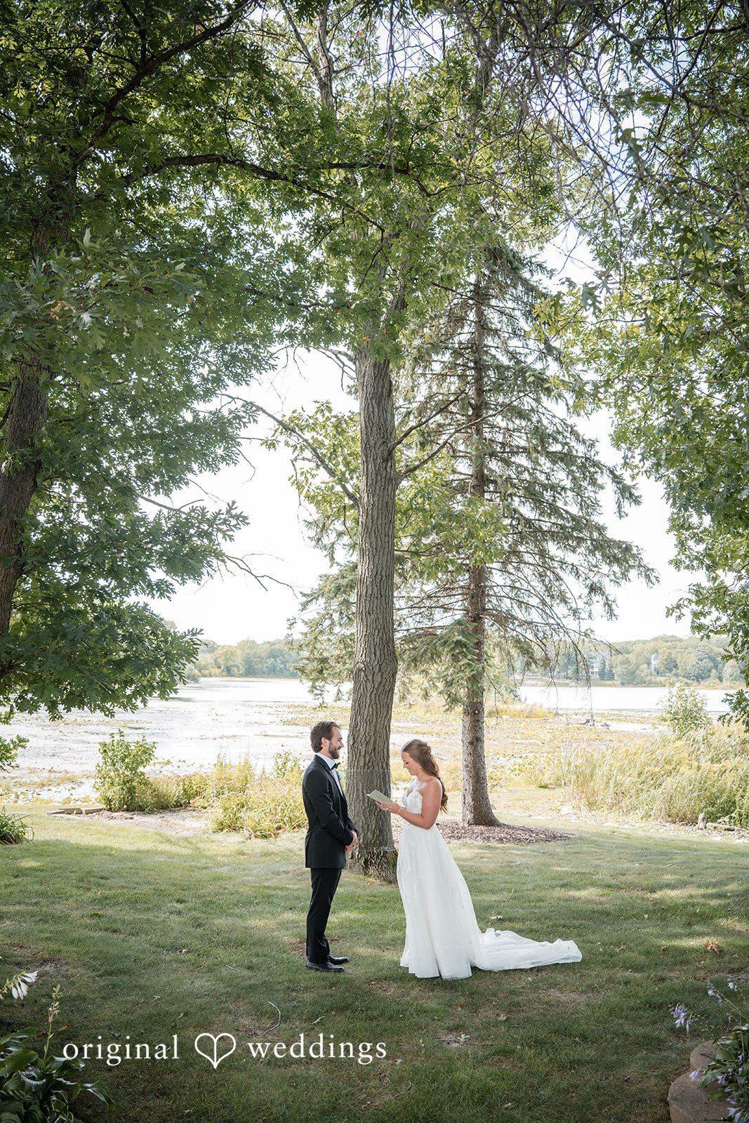 Couple under the trees by the lake at Brianos Charthouse Lakeville
