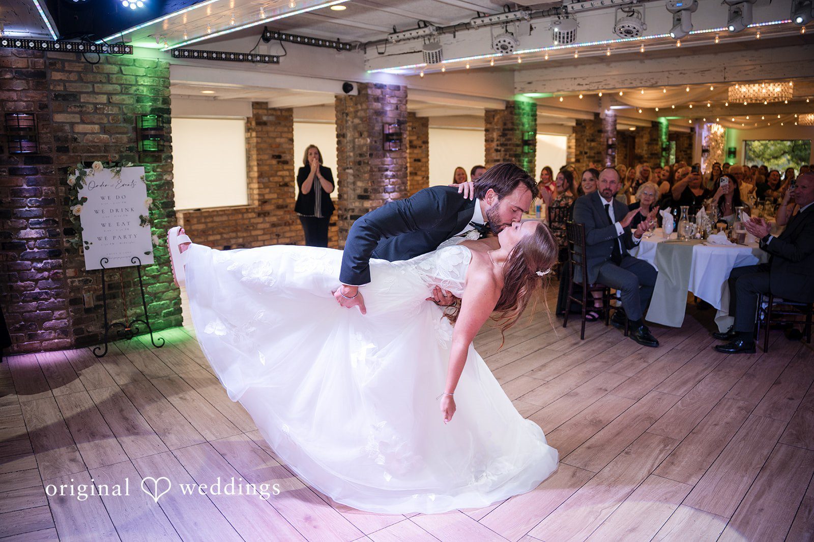 Groom dipping the bride on the dance floor