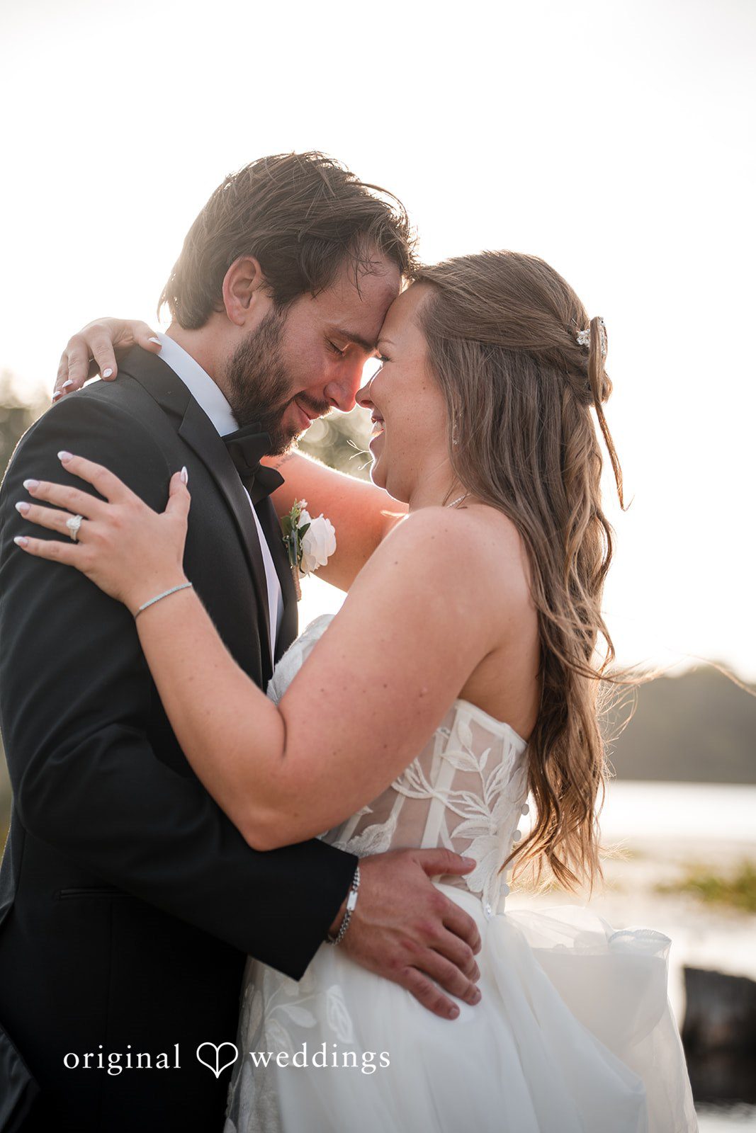 Couple embracing by the lake at Brianos Charthouse Lakeville