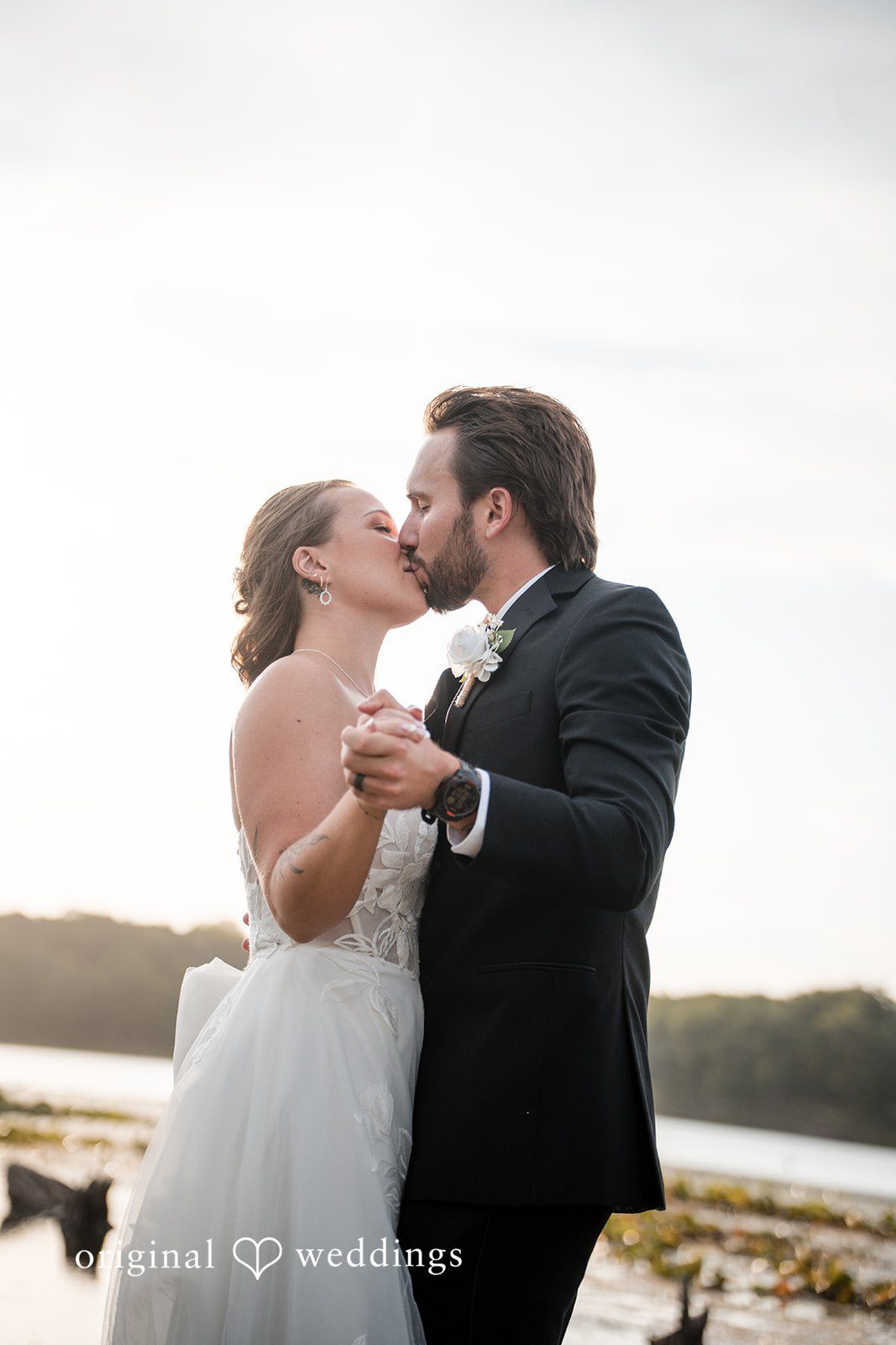 Couple kissing by the water