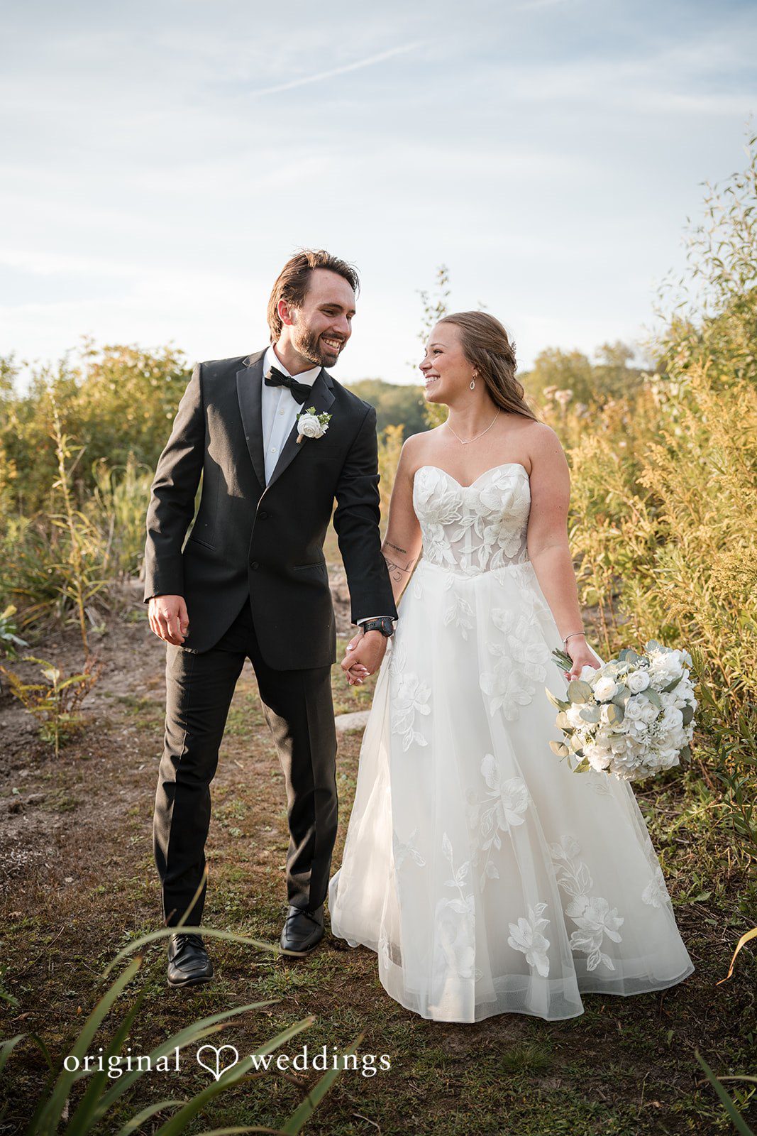 Couple standing in tall grass