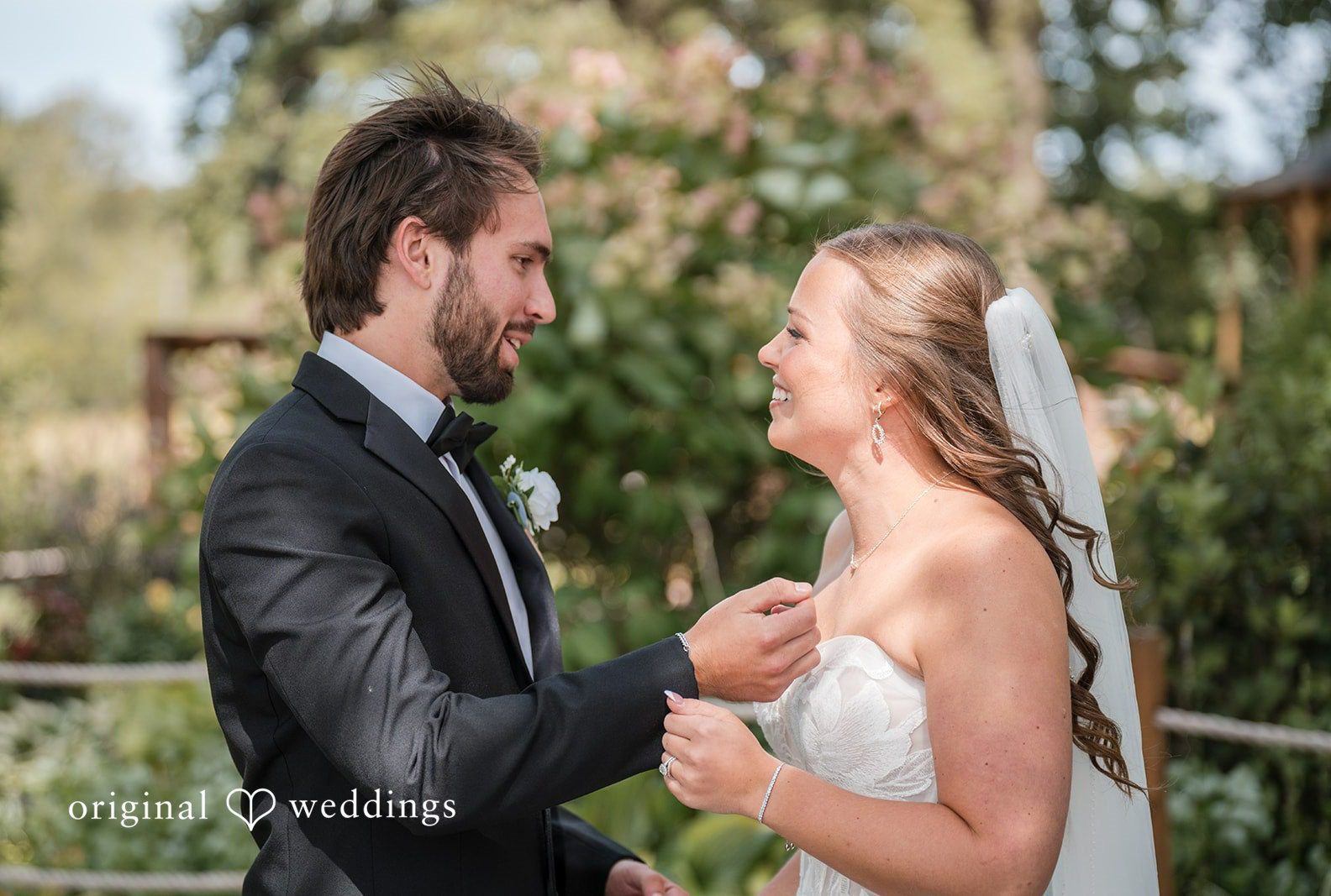 Couple facing each other by the water, captured by Minneapolis wedding photographers from Original Weddings at Brianos Charthouse Lakeville