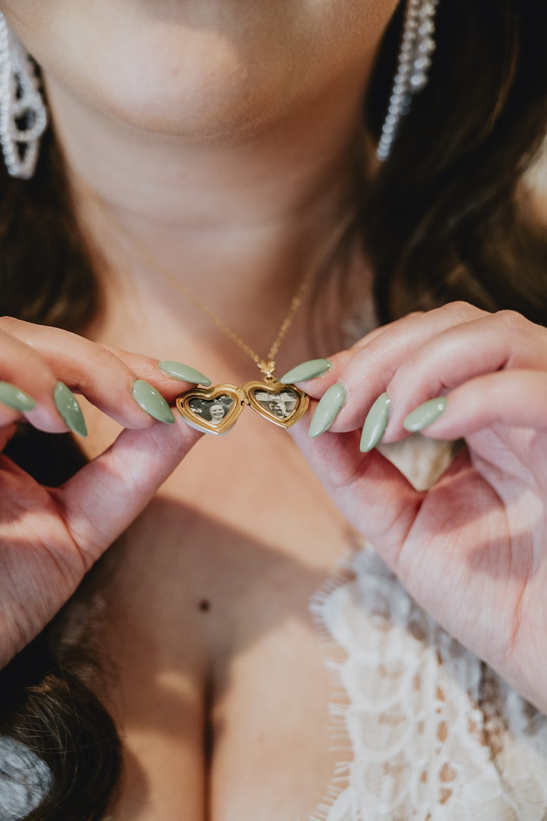 Bride putting on her necklace