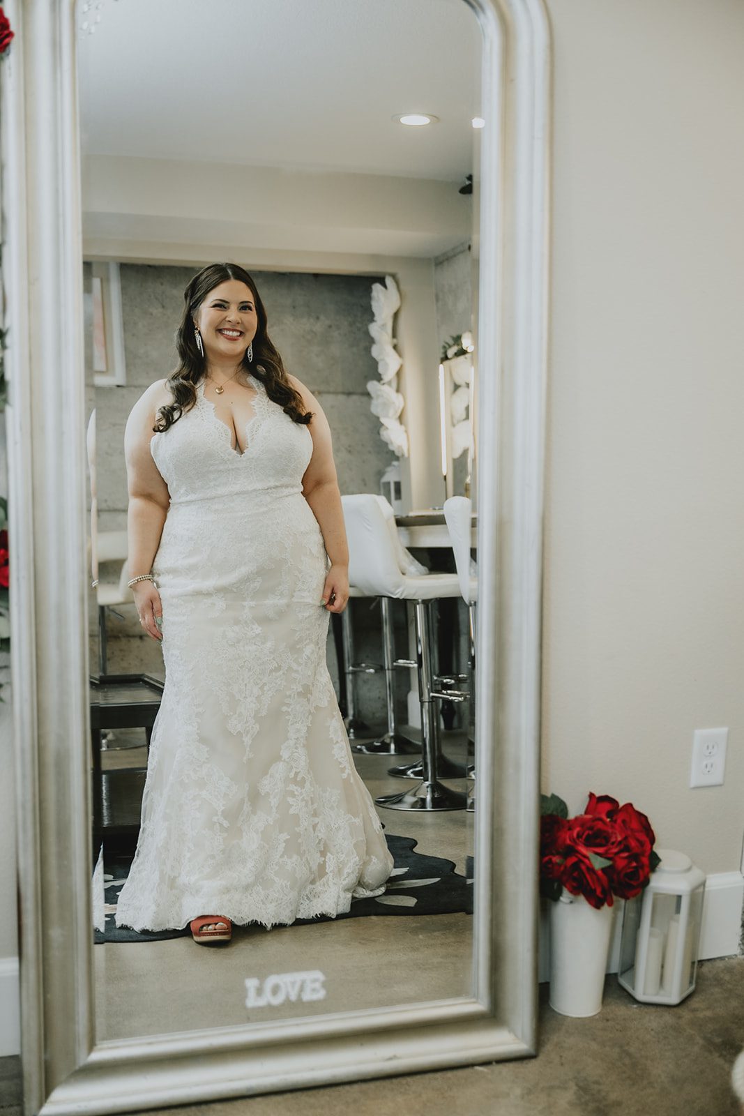 Bride in her gown by the mirror