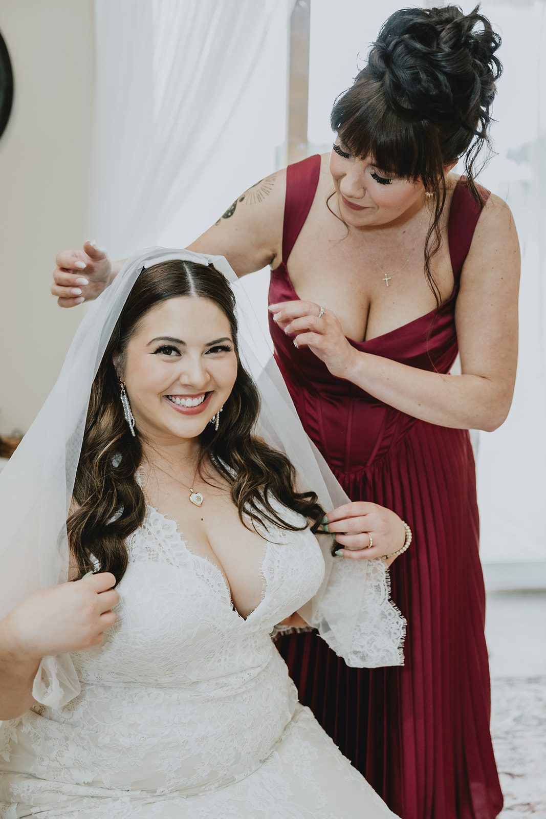 Bride smiling with her bridesmaid