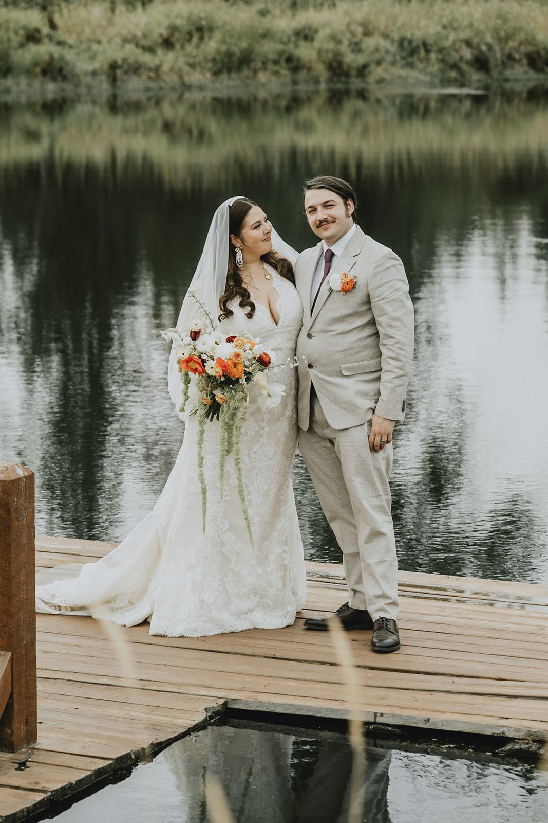 Bride and groom on the dock, captured by Portland wedding photographers from Original Weddings at Brightwater Weddings & Events