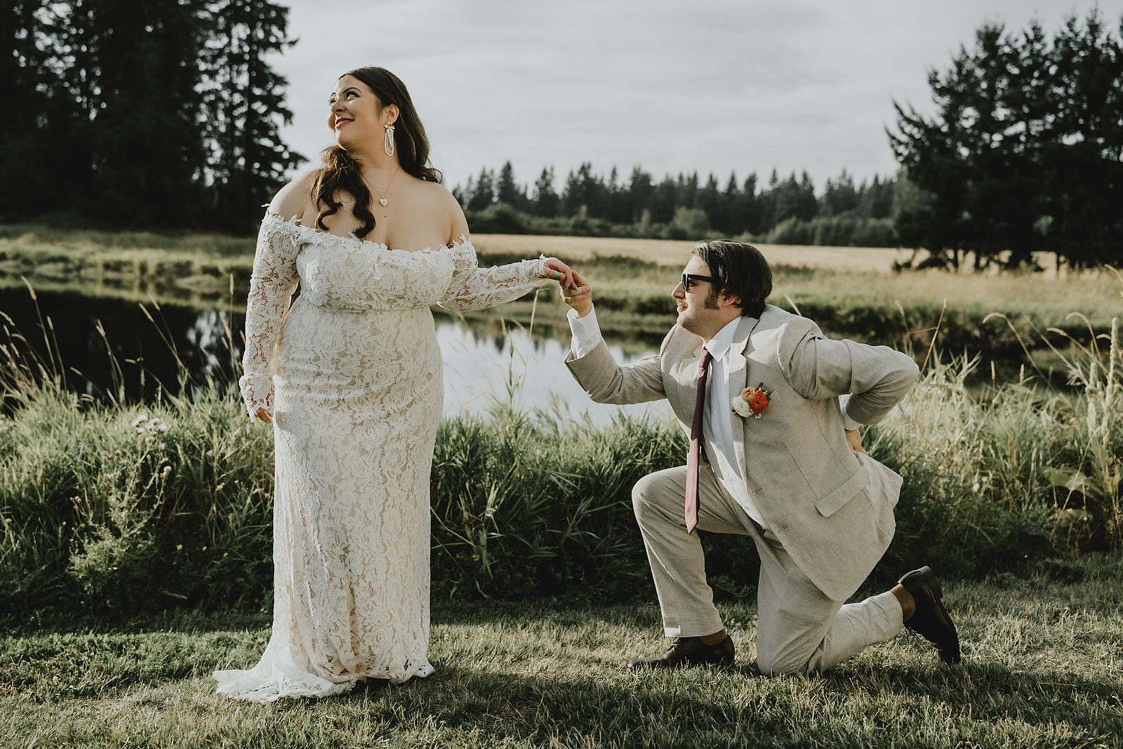 Groom kneeling playfully for the bride
