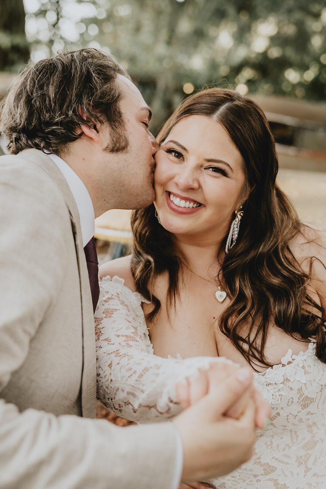 Groom kissing the bride's cheek