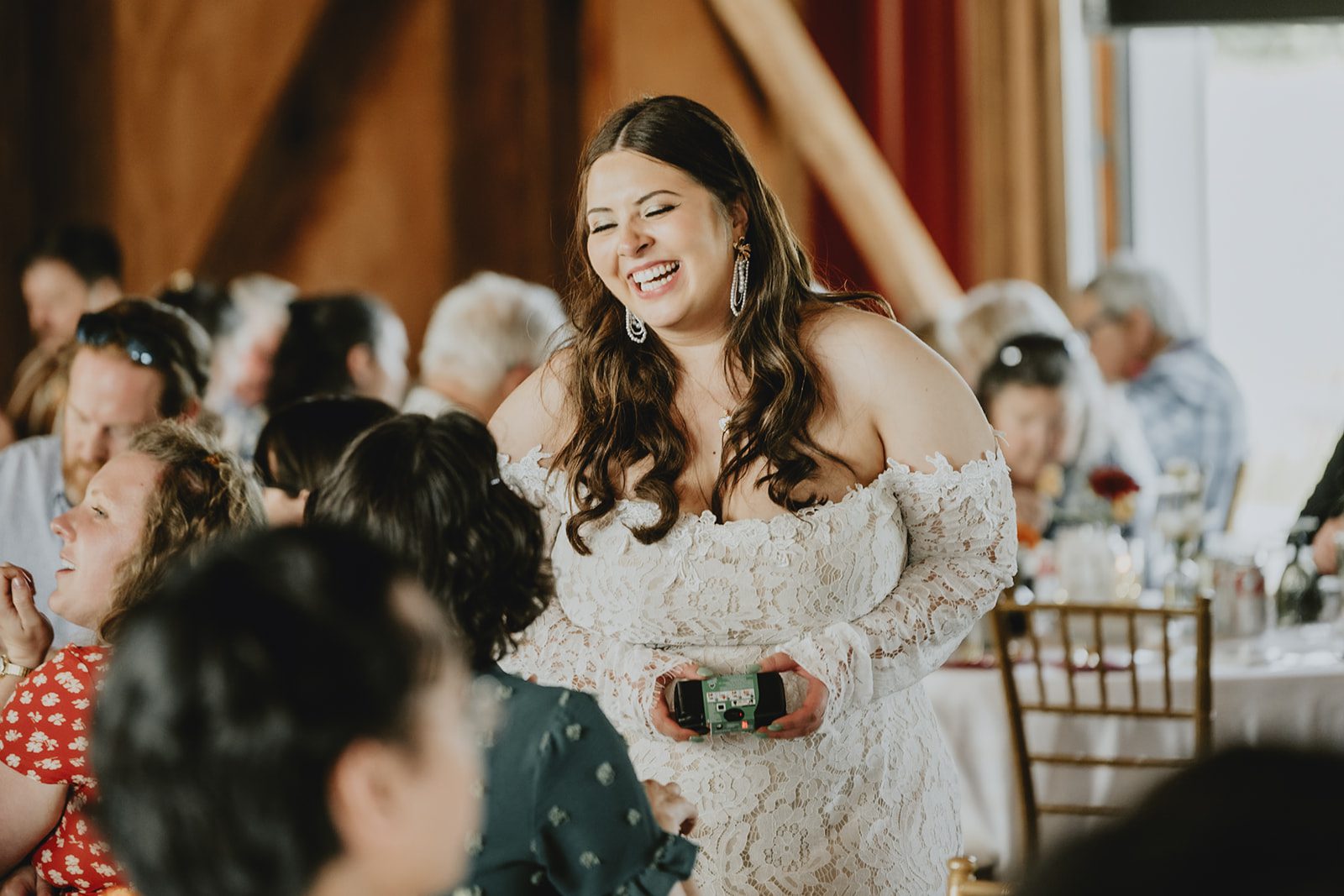 Bride laughing with guests