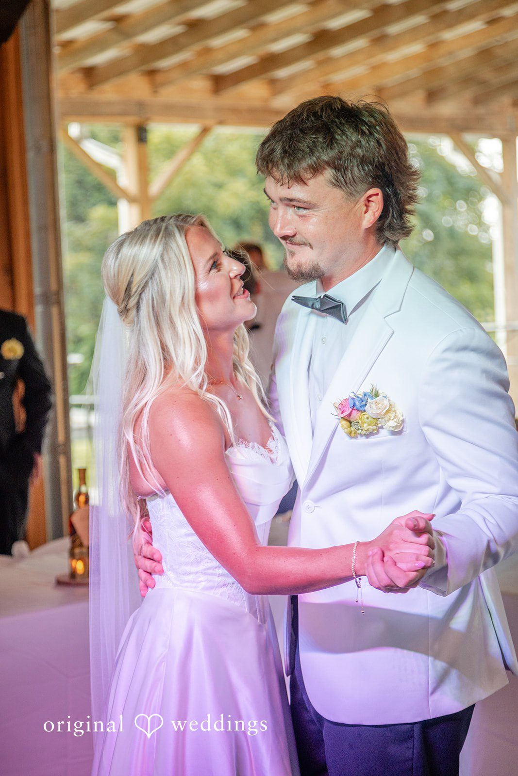 Groom laughing with a bridesmaid