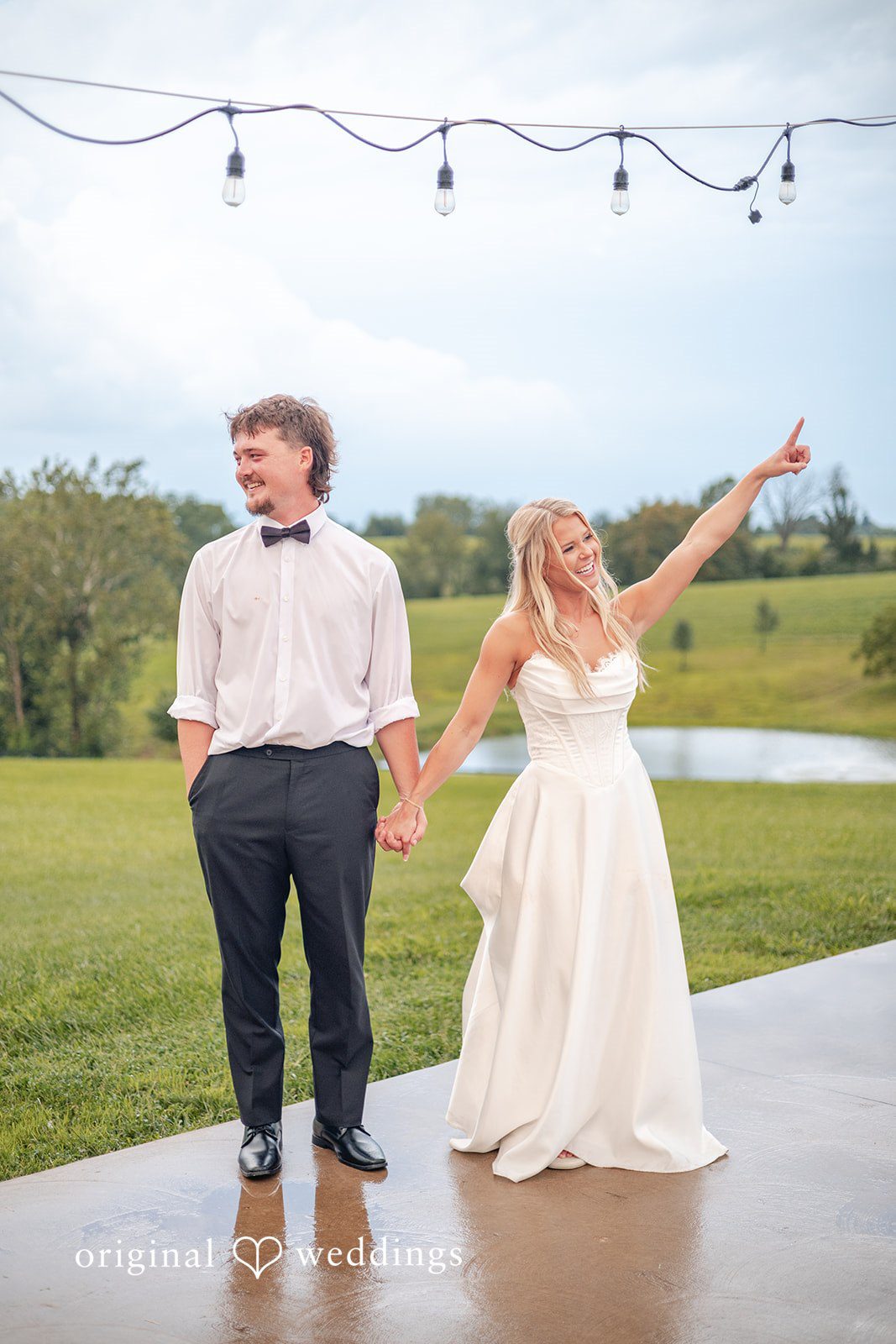 Couple under string lights outside at Bryton Barn