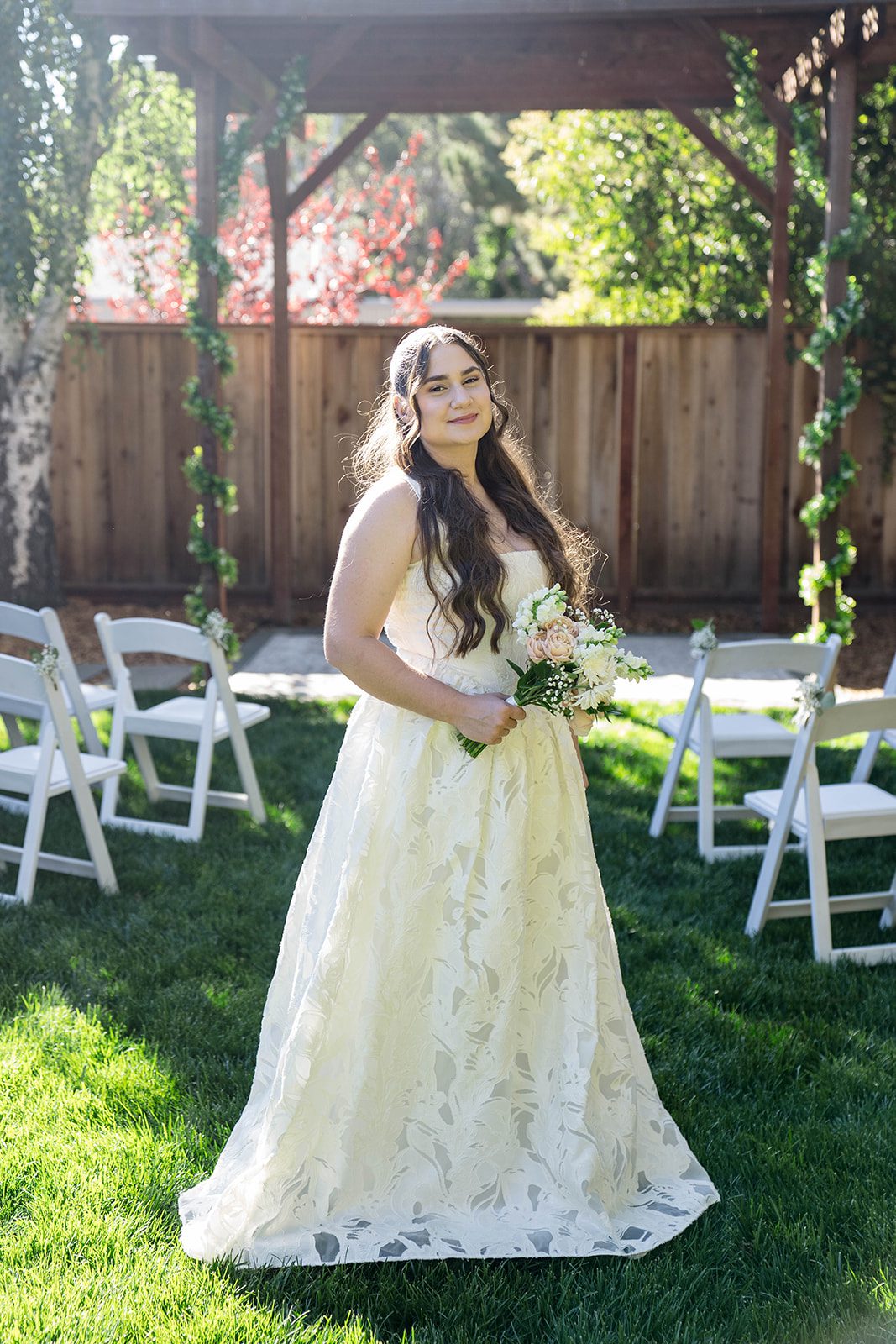Bride in her lace gown in the backyard at a California backyard wedding