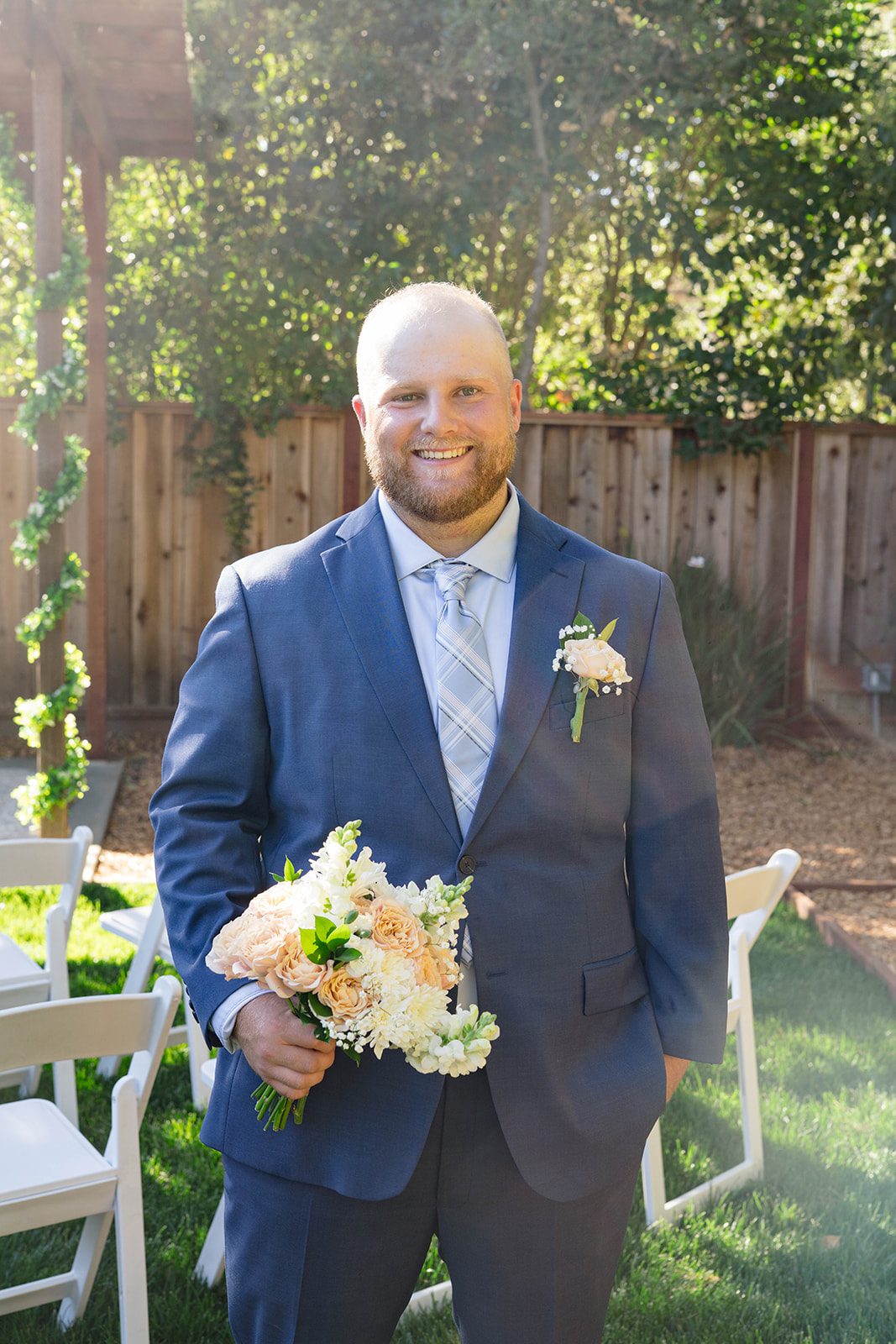 Groom holding the bouquet before the ceremony